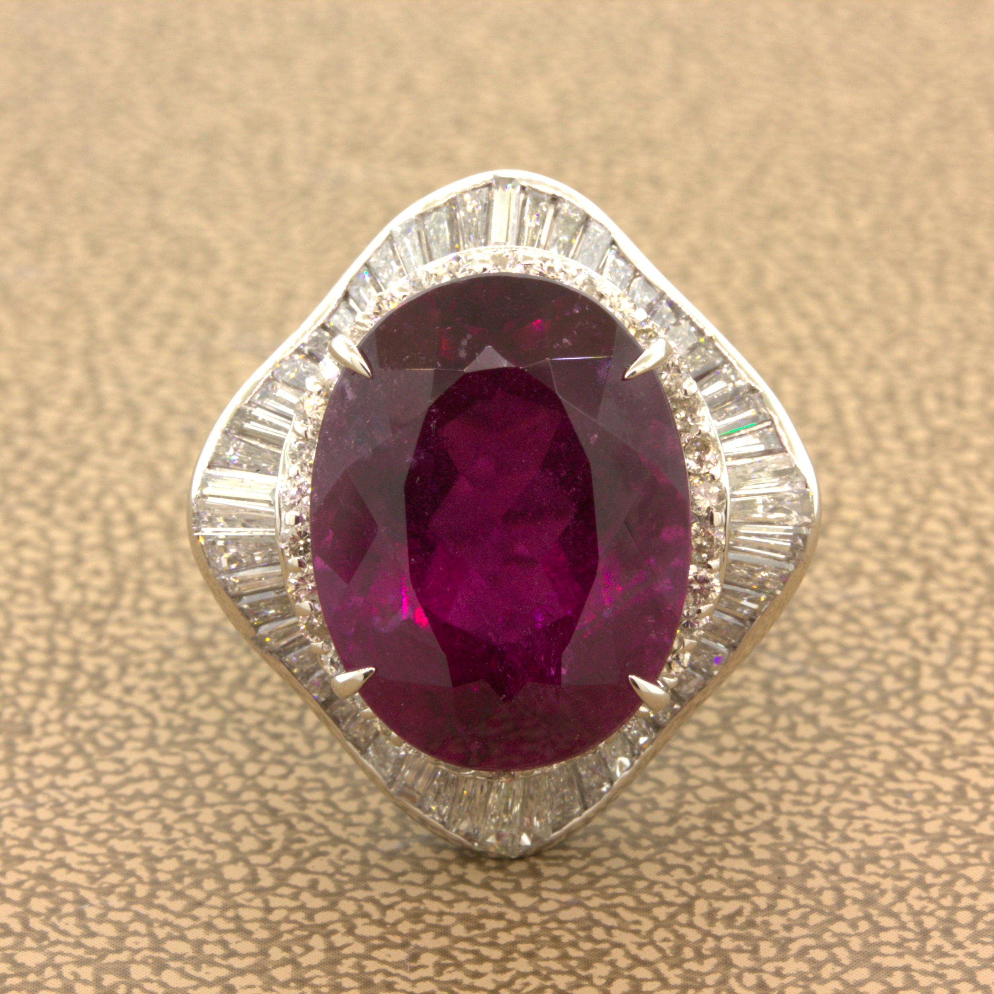 A lovely platinum ring featuring a beautiful razzberry rubellite tourmaline. It weighs 13.61 carats and has a sweet oval shape. While the stone is included, it makes up for it with its deep rich color that glows in the light. It is complemented by