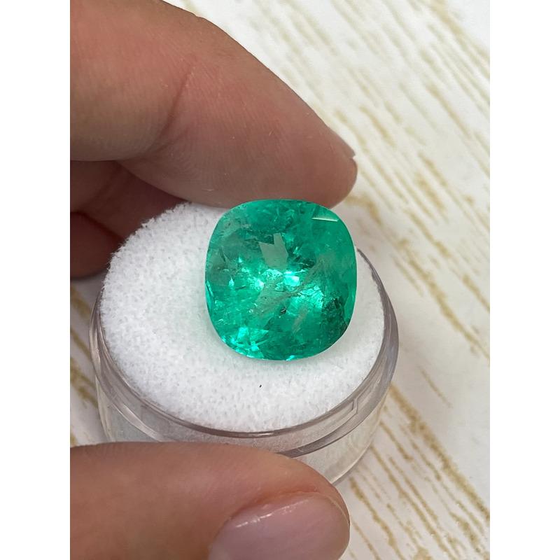 Stone: Emerald
Weight: 13.63-carats
Shape: Cushion Cut
Clarity: Transparent
Luster: Very Good
Color: Medium Green
Measurements: 14.95mm x 14.82mm x 10.84mm
Geographic Origin: Colombia
Treatment: Natural, Oiling

Comments: Due to their growth