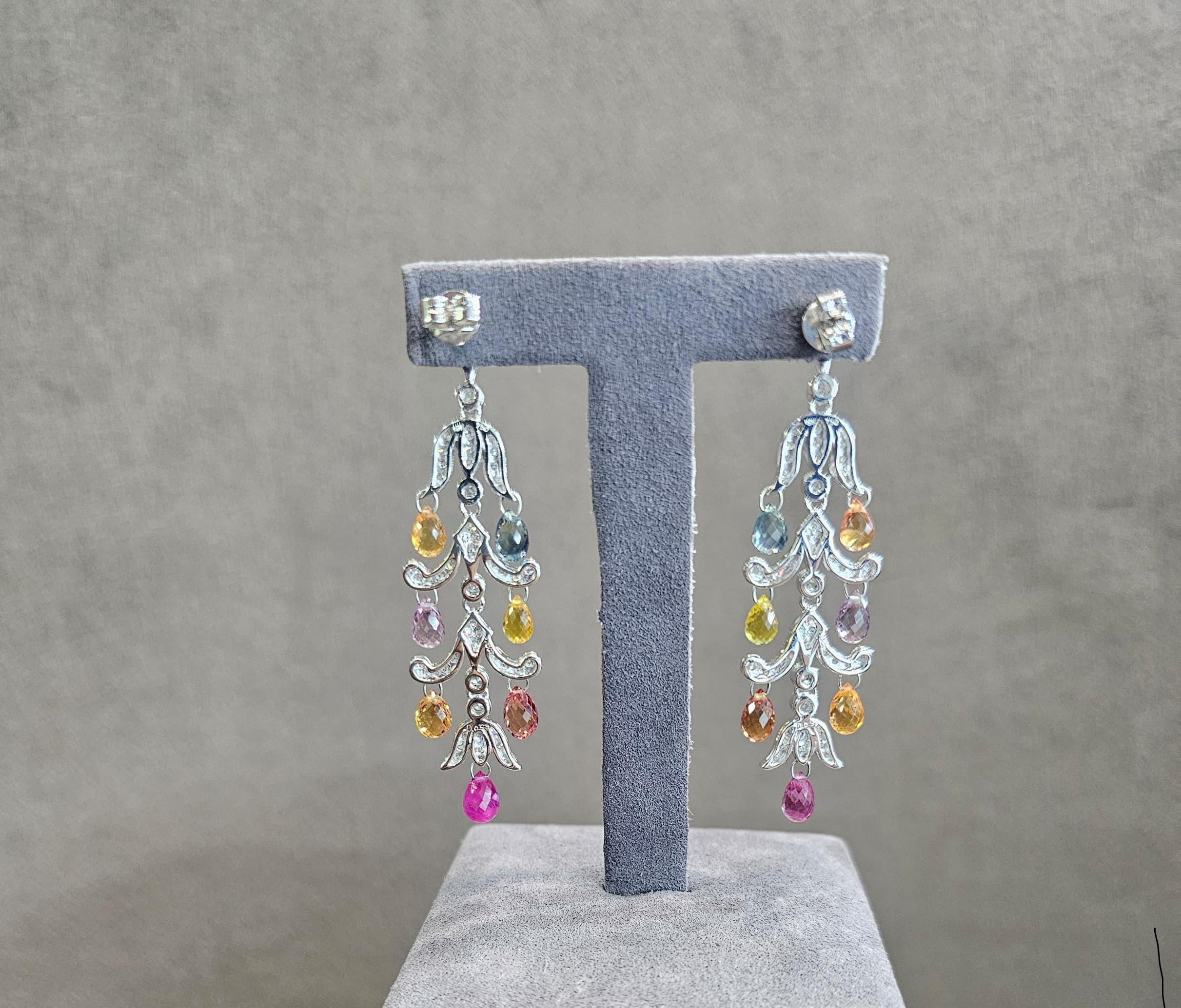 Diamond and Sapphire Briolette Diamond Drops

Exuding timeless elegance and vibrant allure, these exquisite earrings feature a cascade of sapphire briolettes  — delicately faceted to catch the light from every angle. Nestled among them are dazzling 