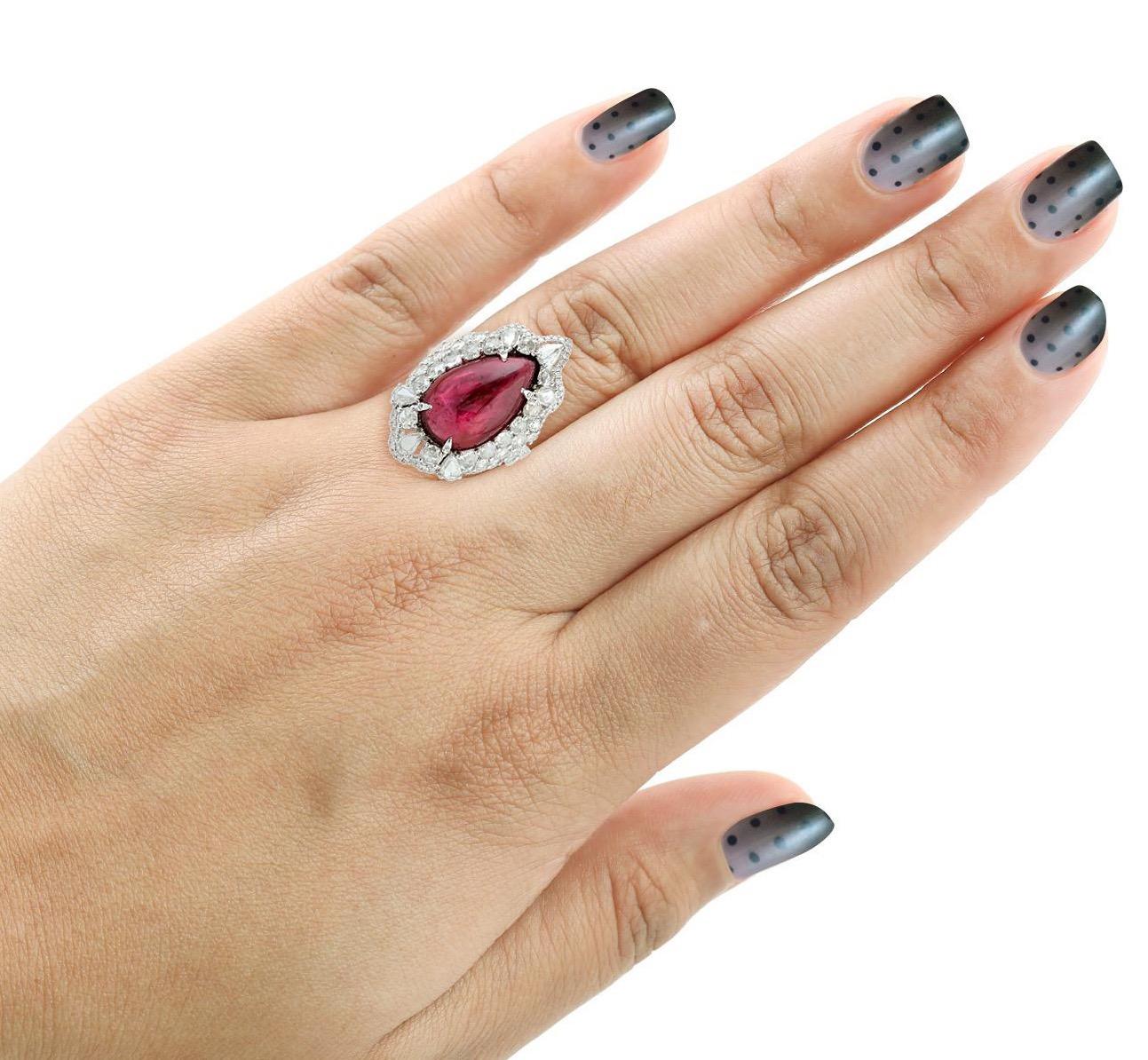 This stunning statement ring has been crafted from 14-karat gold.
It is set in 13.65 carats Rubelite and 2.14 carats glimmering diamonds. 

The ring is a size 7 and may be resized to larger or smaller upon request. 
FOLLOW  MEGHNA JEWELS storefront
