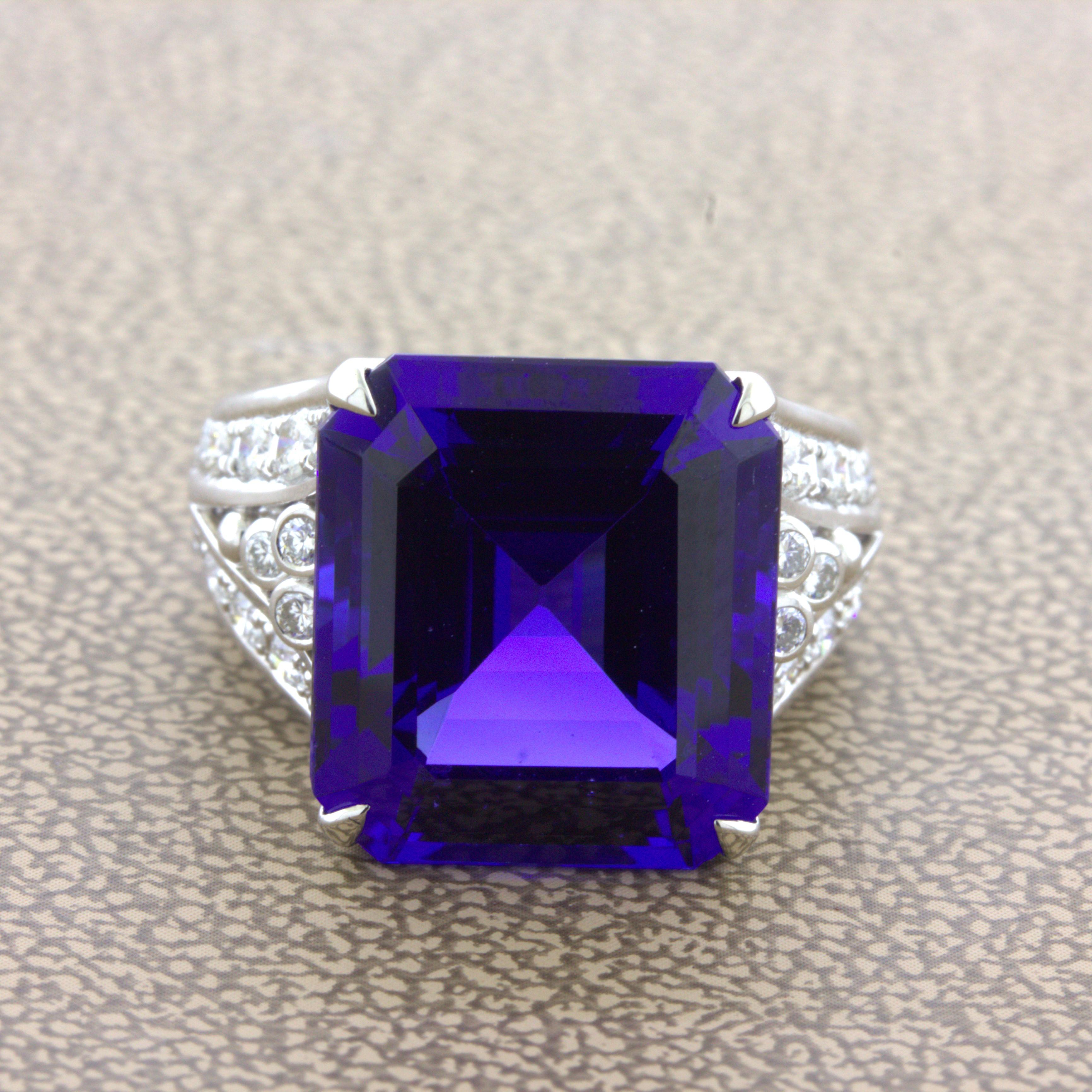 Wow. A superb top gem quality tanzanite weighing an impressive 13.66 carats takes center stage. It has a super rich and vivid purple blue color that flashes and radiates as the stone moves. Adding to that, it has a sleek square emerald-cut shape