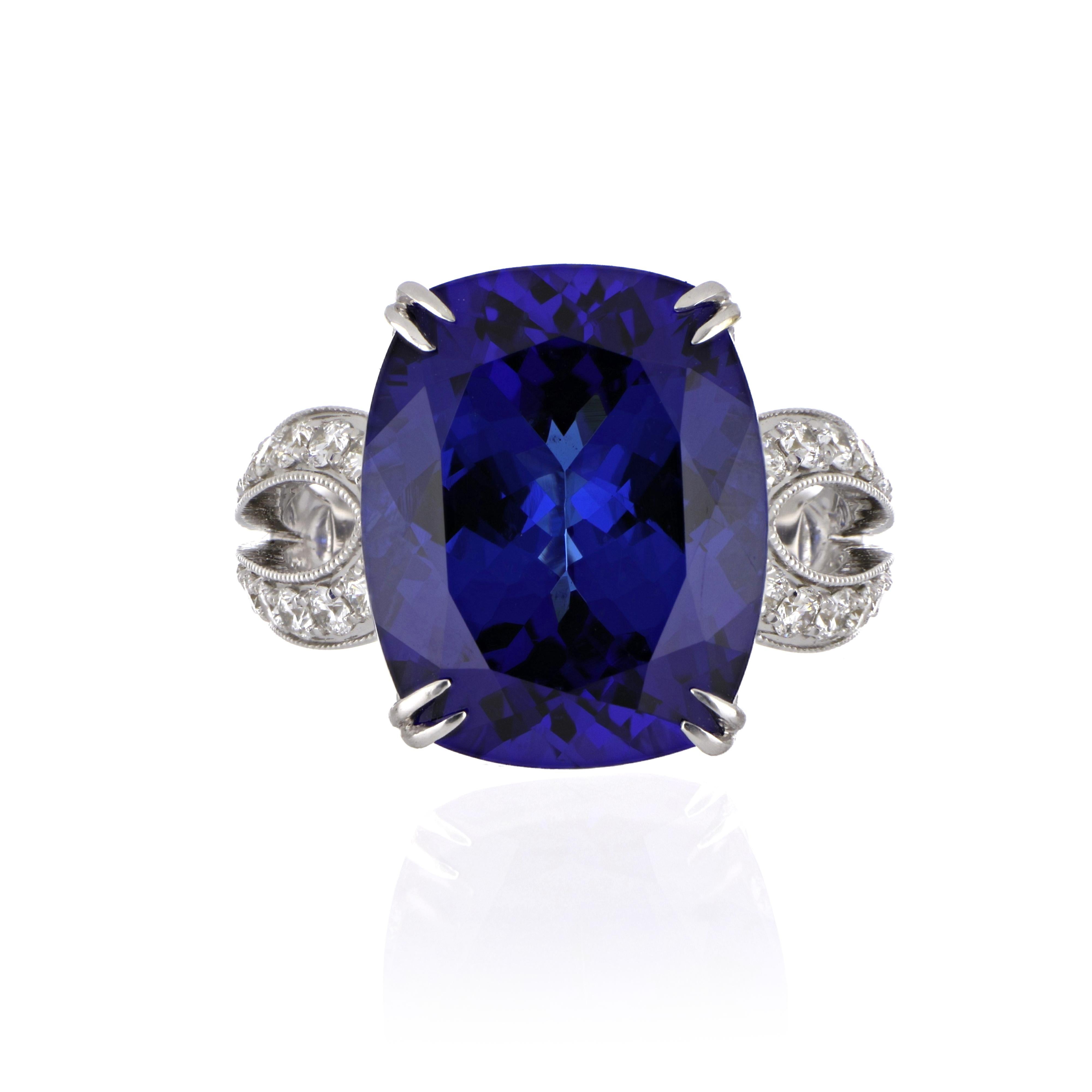 Elegant and exquisitely detailed 18K Ring, centre set with 13.67 Ct Tanzanite, surrounded by and enhanced on shank with micro pave Diamonds, weighing approx. 1.05 total carat weight. Beautifully Hand crafted in 18 Karat white Gold.

Stone Size:
