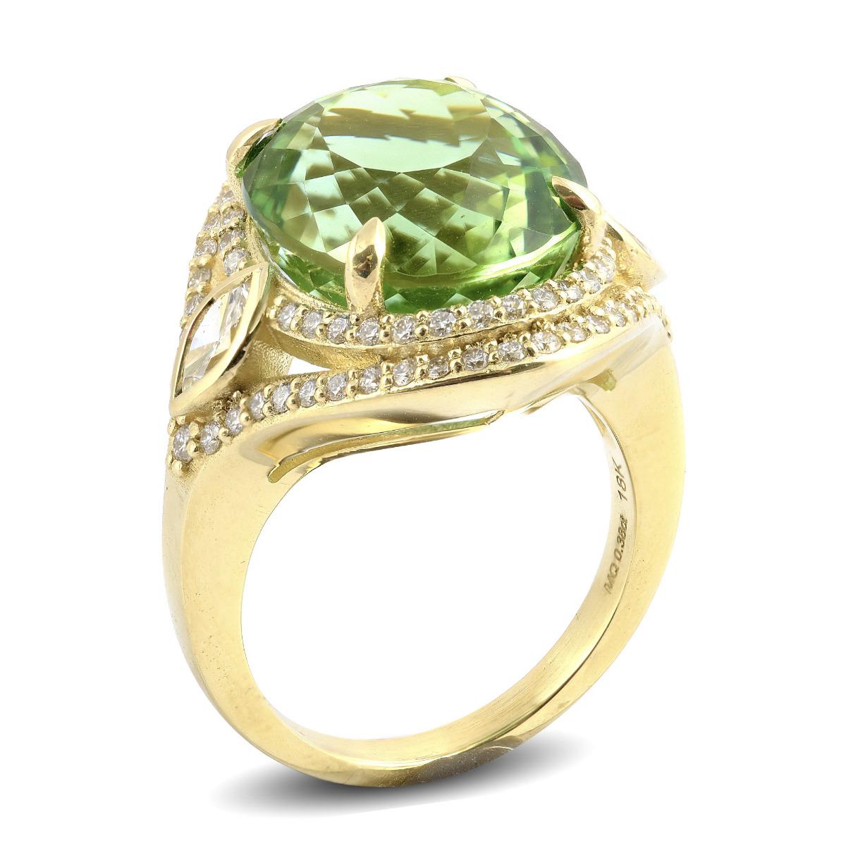 Set within a halo of diamonds, in an 18K yellow gold setting, this gem’s greenish brown color appears different from different angles giving the ring a different aura.