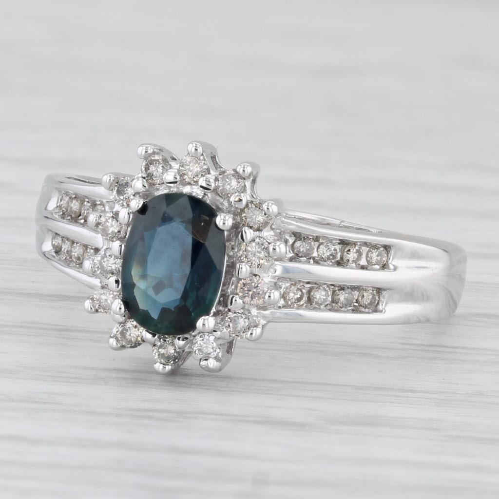 Gemstone Information:
- Natural Sapphire -
Carats - 1ct 
Cut - Oval
Color - Dark Blue
Treatment - Heated

- Natural Diamonds -
Total Carats - 0.36ctw
Cut - Round Brilliant
Color - J - K
Clarity - SI2 - I1

Metal: 14k White Gold
Weight: 3.3 Grams