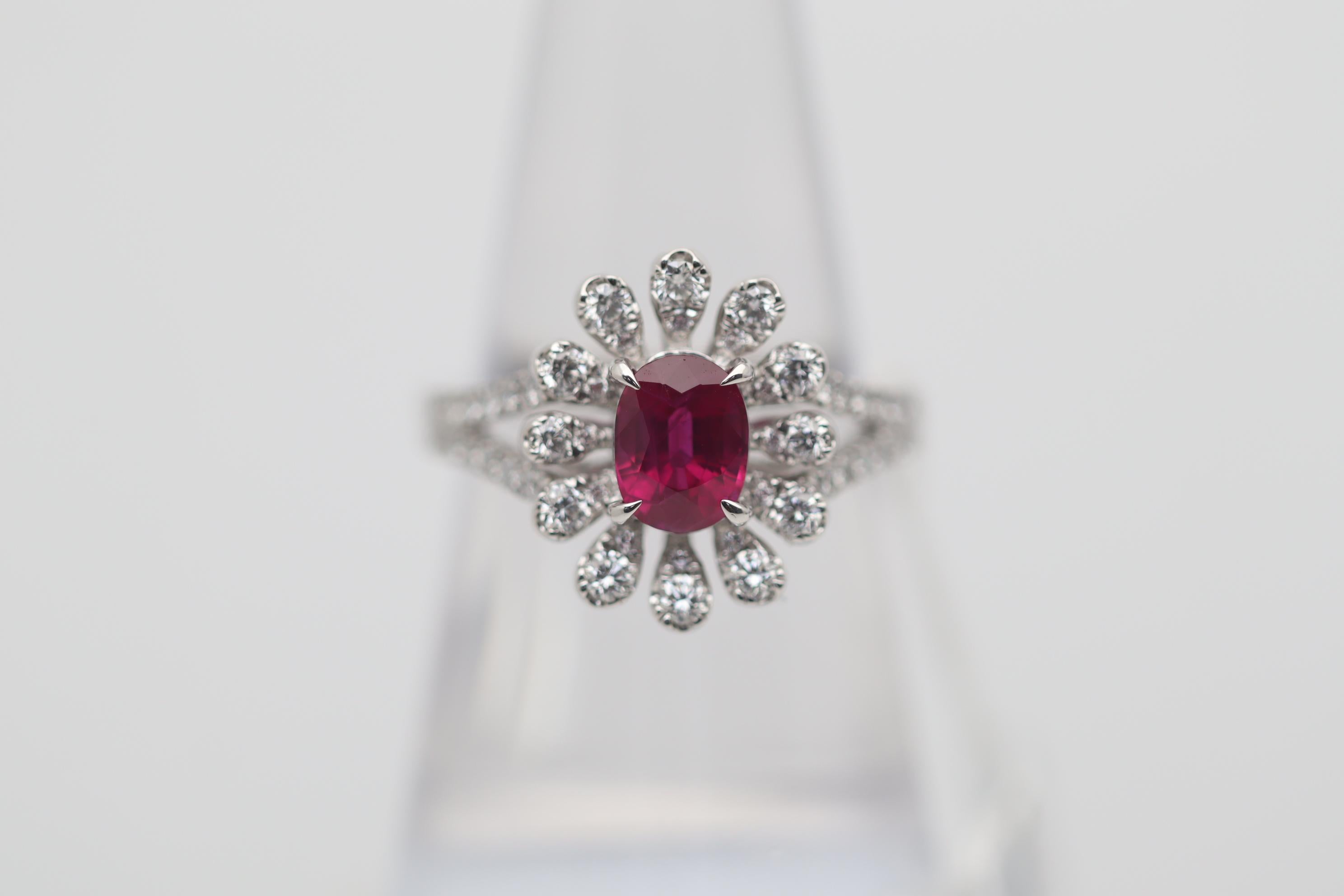 A rich and vibrant ruby from the famous mines of Burma take center stage. It weighs 1.37 carats and has a rich intense color seen in finer Burmese stones. Certified as natural with Burmese origin by the GIA. It is complemented by 0.60 carats of