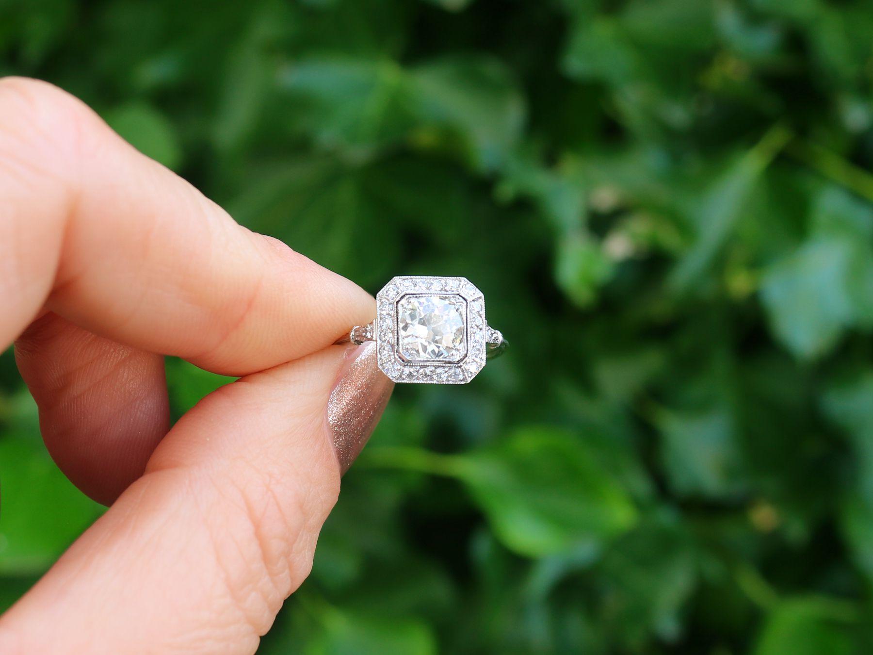 A stunning antique and contemporary 1.37 carat diamond and platinum halo style dress ring; part of our diverse diamond jewelry collections.

This stunning, fine and impressive halo diamond ring has been crafted in platinum.

The pierced decorated,