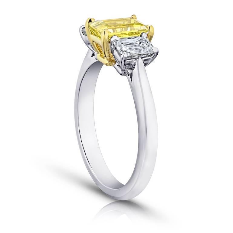 1.37 carat emerald cut (natural no heat) yellow sapphire set with two rectangular radiant cut  diamonds weighing .91 carats set in a platinum and 18k Yellow Gold Ring
