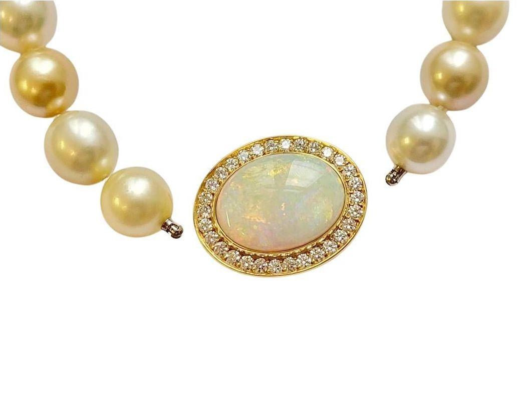 An absolutely stunning necklace, created by Wagner Preziosen. 
31 Harlekin Southsea Pearls, 12.4-14.3 mm in diameter, of the finest lustre are complemented by an magnificent clasp made of an 13.7 carat opal cabochon of superb quality with a vivid