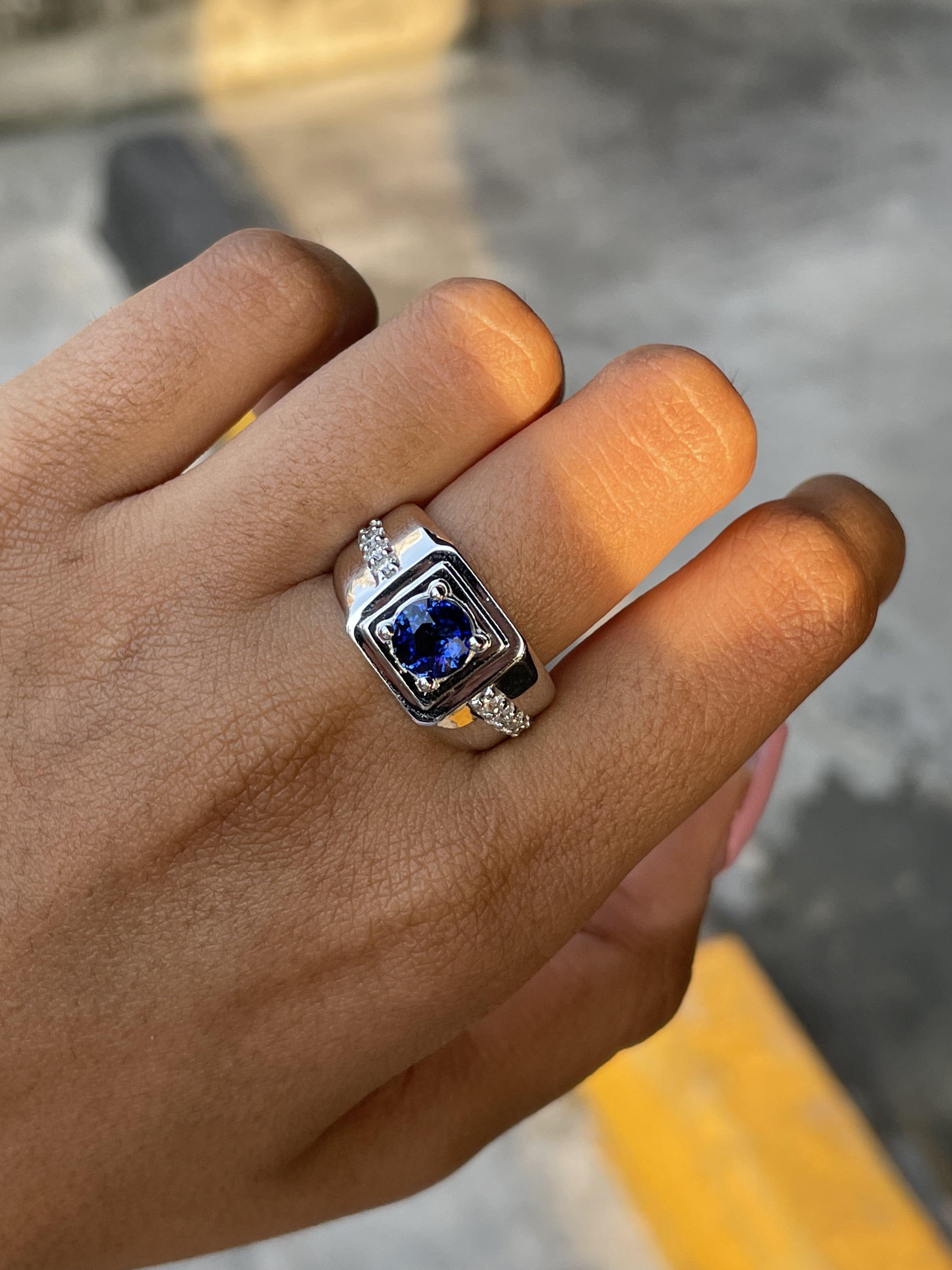 Presenting a lustrous, gemstone ring for men,  that will win over anyone’s heart with its sheer beauty and sophistication. This stunning piece showcases a majestic, round-cut Sapphire as its centerpiece, radiating a breathtaking luster and boasting