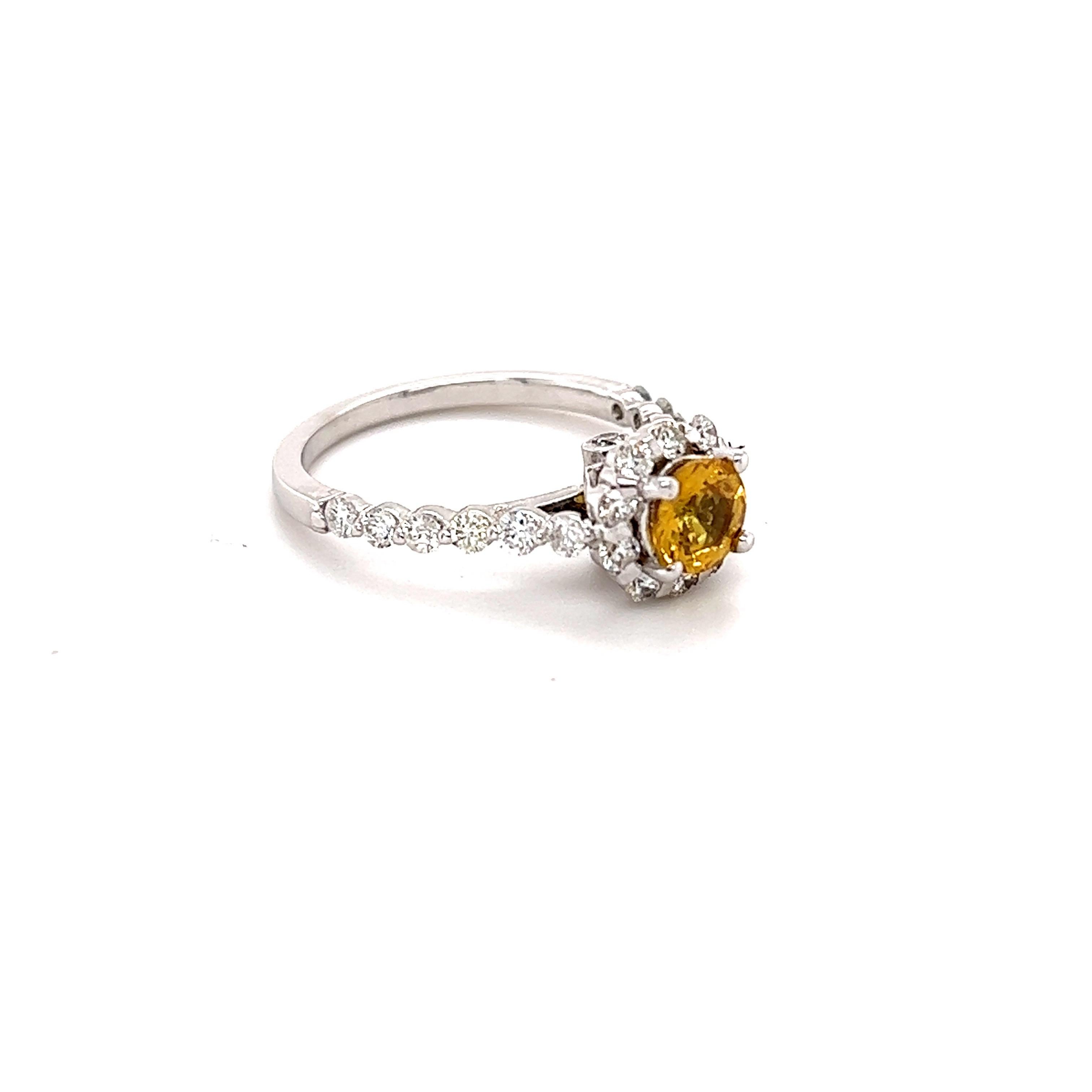 This beautiful ring has a Natural Round Cut Yellow Sapphire with Heat that weighs 0.72 Carats. The measurements of the Yellow Sapphire measures at approximately 5 mm. 

The ring is embellished with 18 Round Cut Diamonds that weigh 0.65 Carats with a