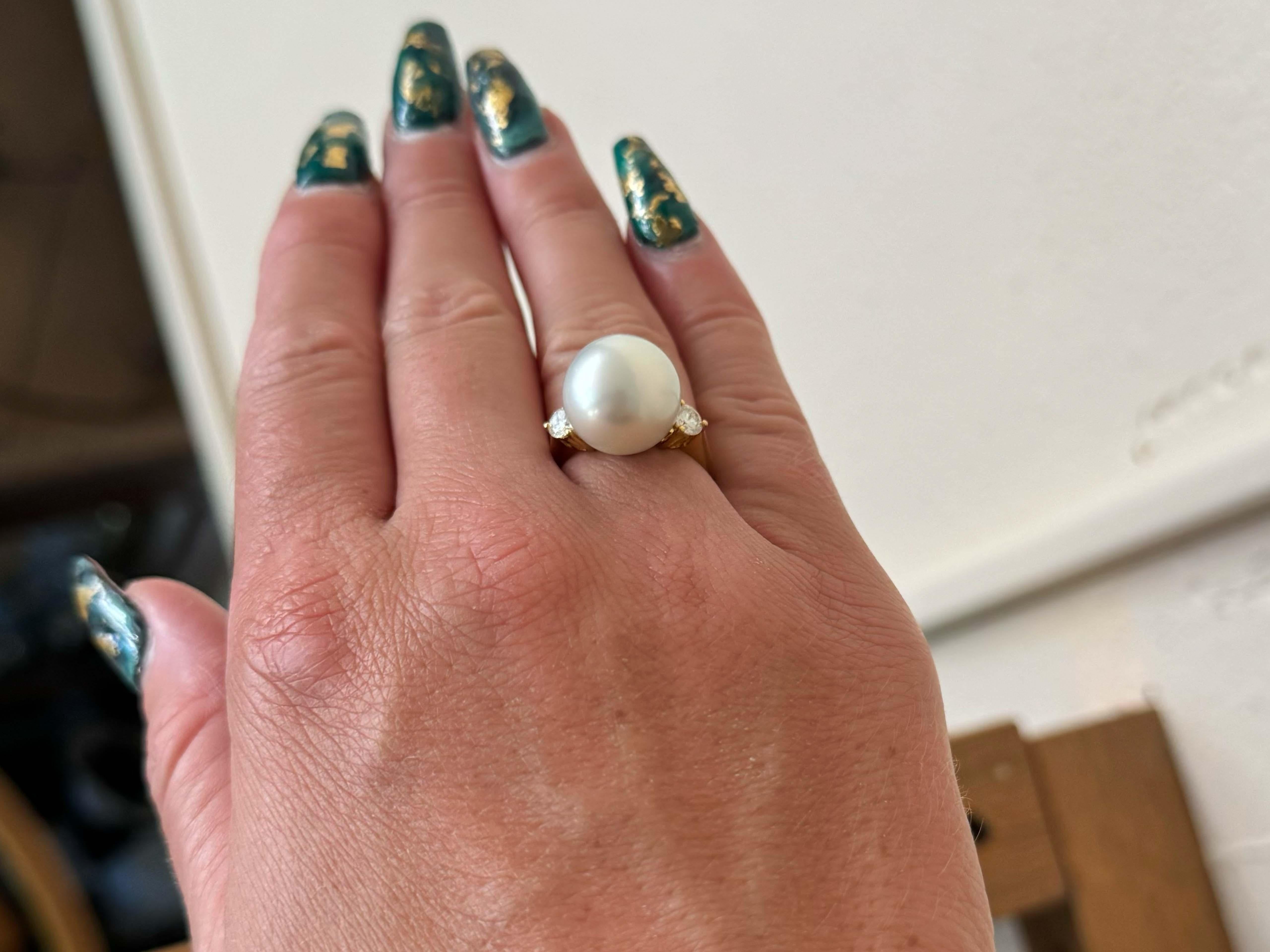 Ring Specifications:

Metal: 18k Yellow Gold

Total Weight: 7.7 Grams

Pearl Diameter: 13.7 mm

Pearl Count: 1 south sea pearl

Diamond Count: 2 brilliant cut

Diamond Color: G-H

Diamond Clarity: VS

Diamond Carat Weight: 0.50 carats

Ring Size: 