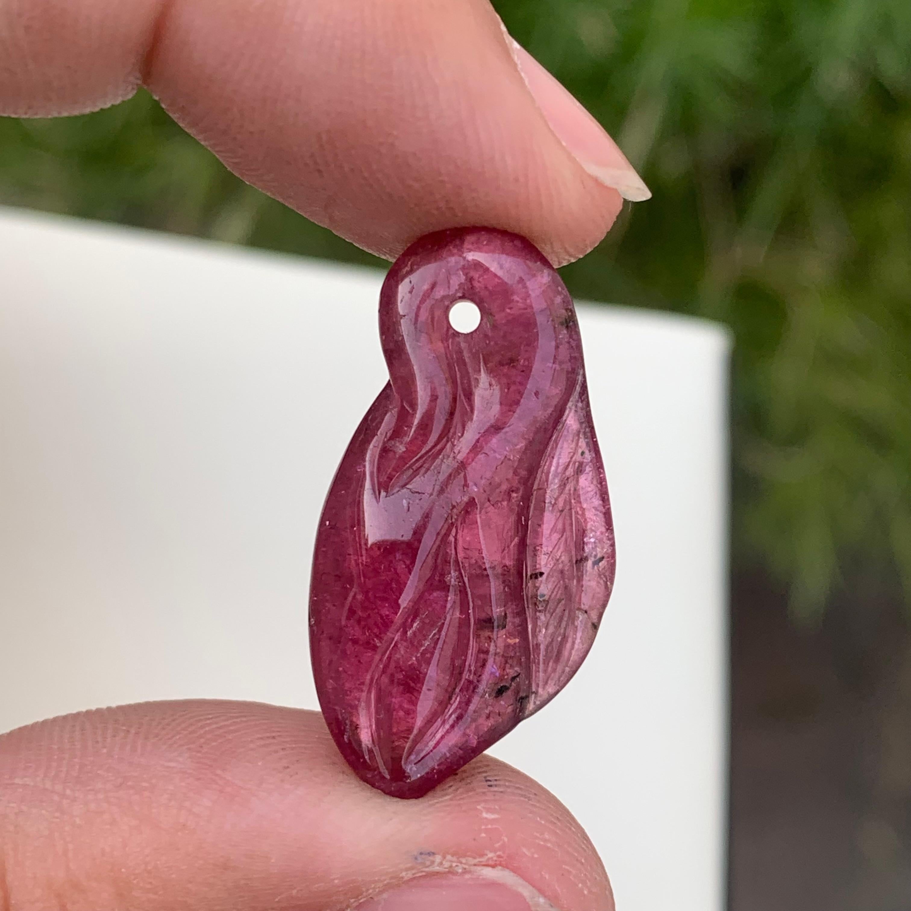 Glamorous Rubellite Tourmaline Drilled Craving From Africa 
Weight : 13.70 Carats
Dimensions : 2.8 x 1.4 x 0.5 Cm
Origin : Madagascar Africa
Clarity : SI
Color: Pink 
The rubellite is a transparent gemstone from the colorful family of the