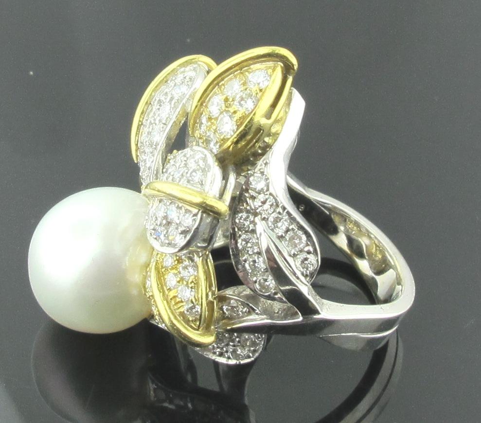 A 13.70 mm white South Sea Pearl set in an 18 karat yellow & white gold  with a petal and leaf design filled with 93 round brilliant cut diamonds with a total weight of 4.00 carats.  Diamonds are H color, VS. 18 grams of gold.  Ring size is 7.5.