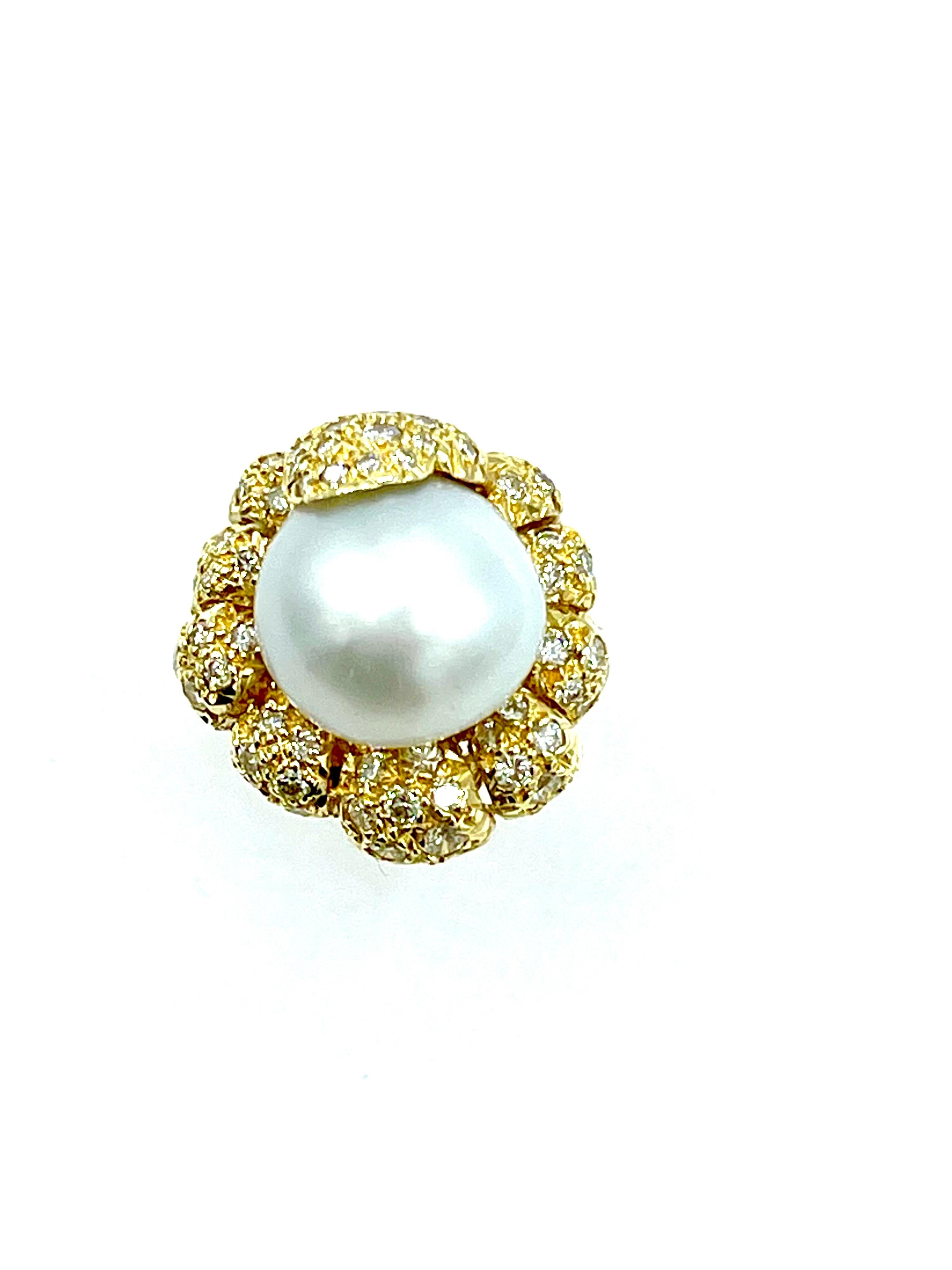 This is such an amazing fashion ring!  The 13.70mm South Sea Pearl is set with waves of round brilliant pave Diamonds surrounding in 18k yellow gold.  The diamonds combine for a total weight of 1.00ct, and are graded F color, VS clarity.  The ring