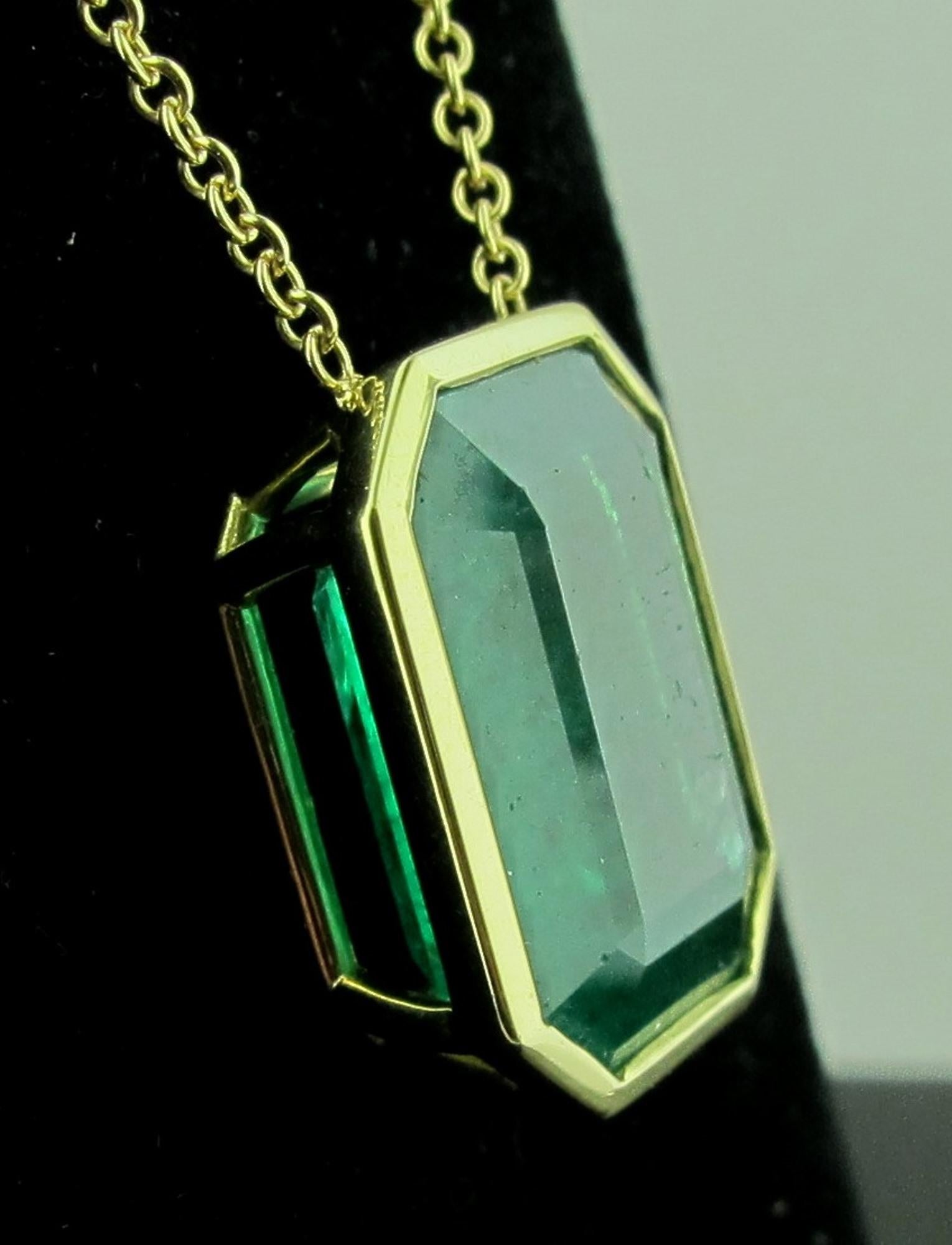 Set in 18 karat yellow gold is a 13.71 carat emerald cut Emerald with an 18 karat yellow gold chain, 18