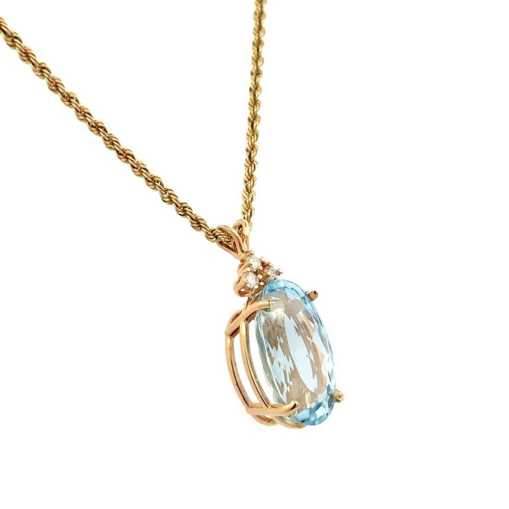 Simply Beautiful! Finely detailed Oval Blue Topaz and Diamond Gold Statement Pendant Necklace. Featuring a securely Hand set Oval Blue Topaz, weighing approx. 13.71 Carats. Enhanced with Diamonds, approx. 0.15tcw. Hand crafted 14K Yellow Gold