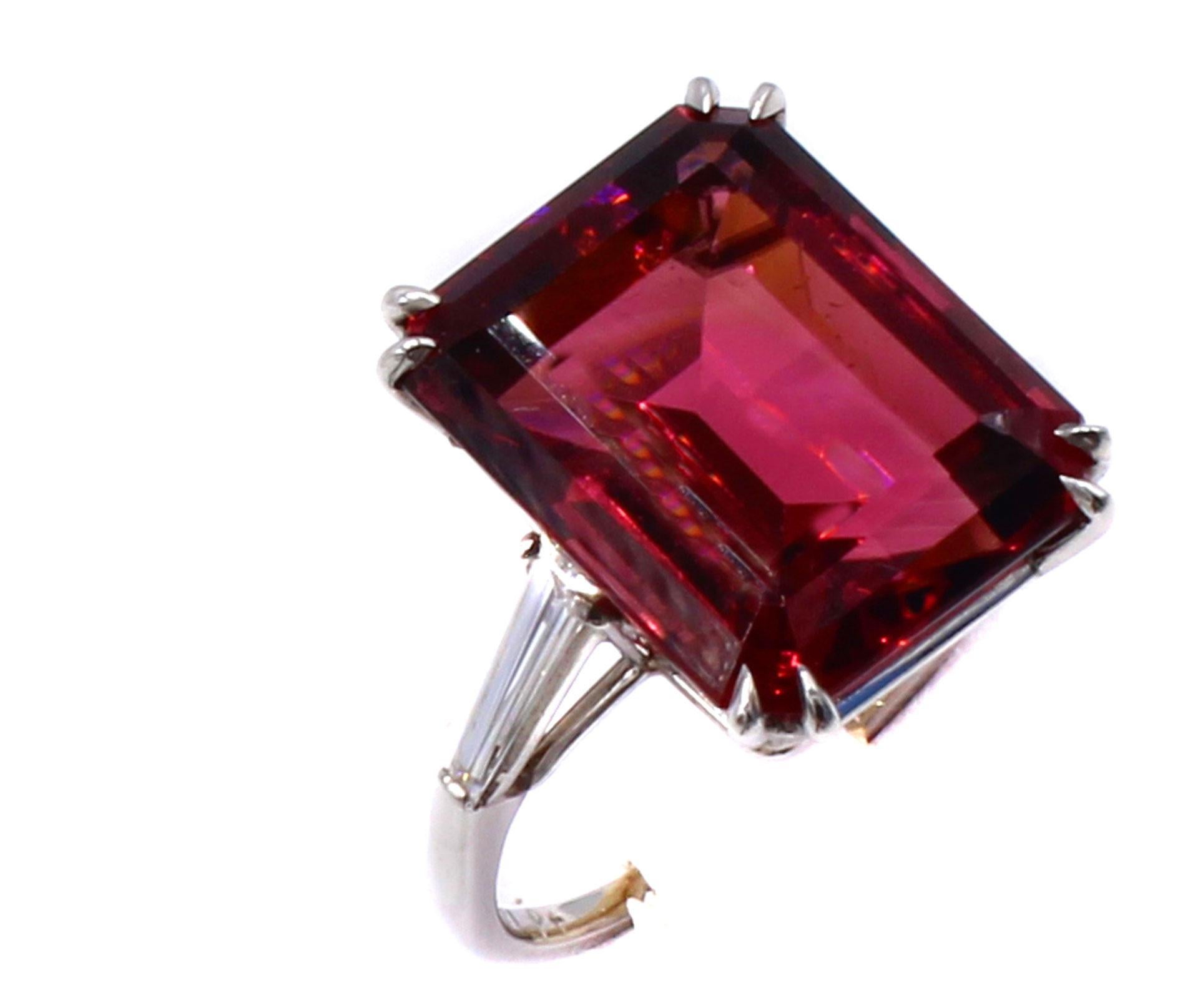 



A perfectly proportioned gem Rubellite step-cut, weighing 13.77 carats is the center piece of this hand-crafted chic and bold platinum ring. Securely held by 2 fine eagle-claw prongs on each corner and set into a basket of 2 spaced wires, this