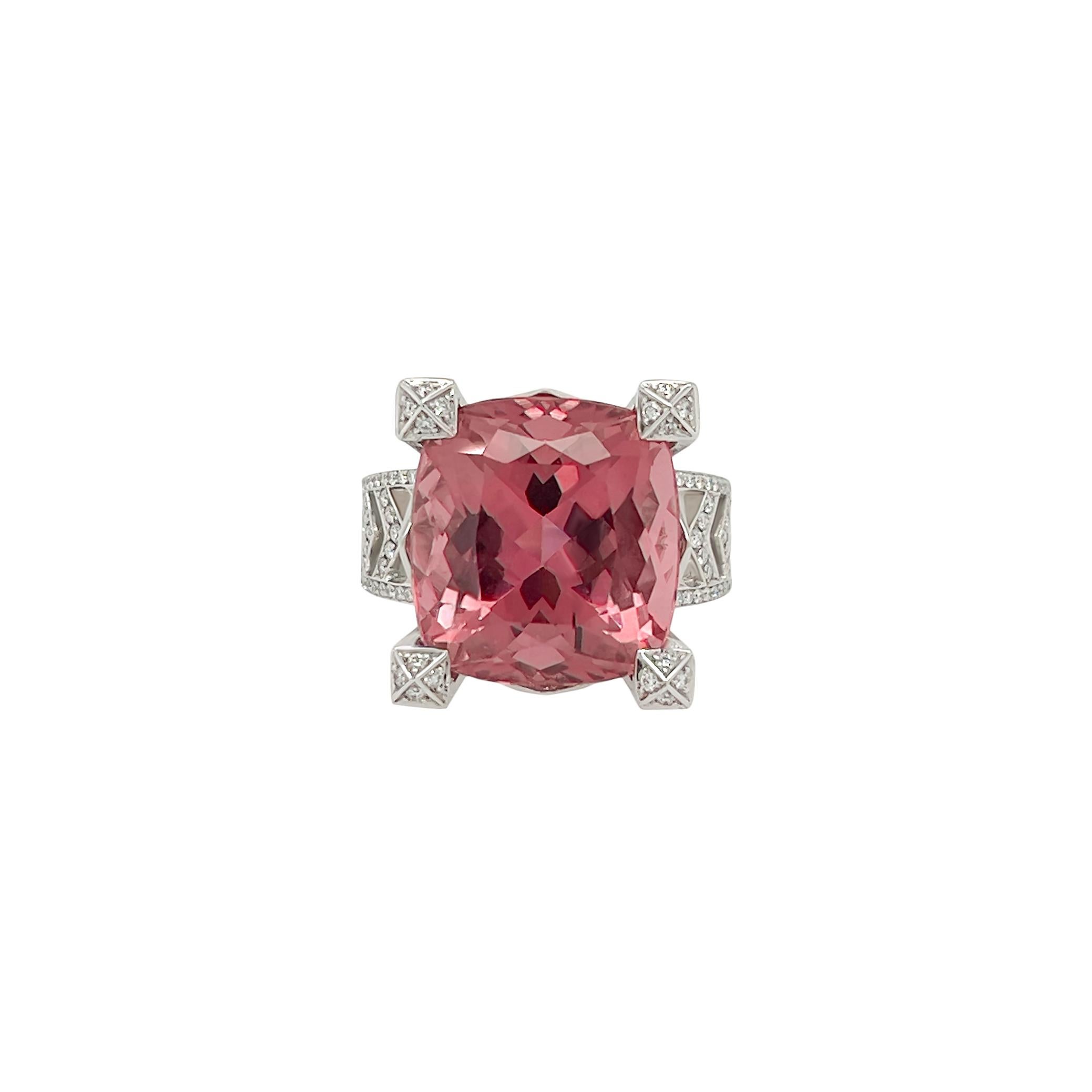 This stunning 13.77 carat natural pink tourmaline is the highlight of this ring. The modern design showcases the centre stone's beauty with simply decorating it with nearly 1 carat of vvs pave’d diamonds in a chevron design. The center stone is