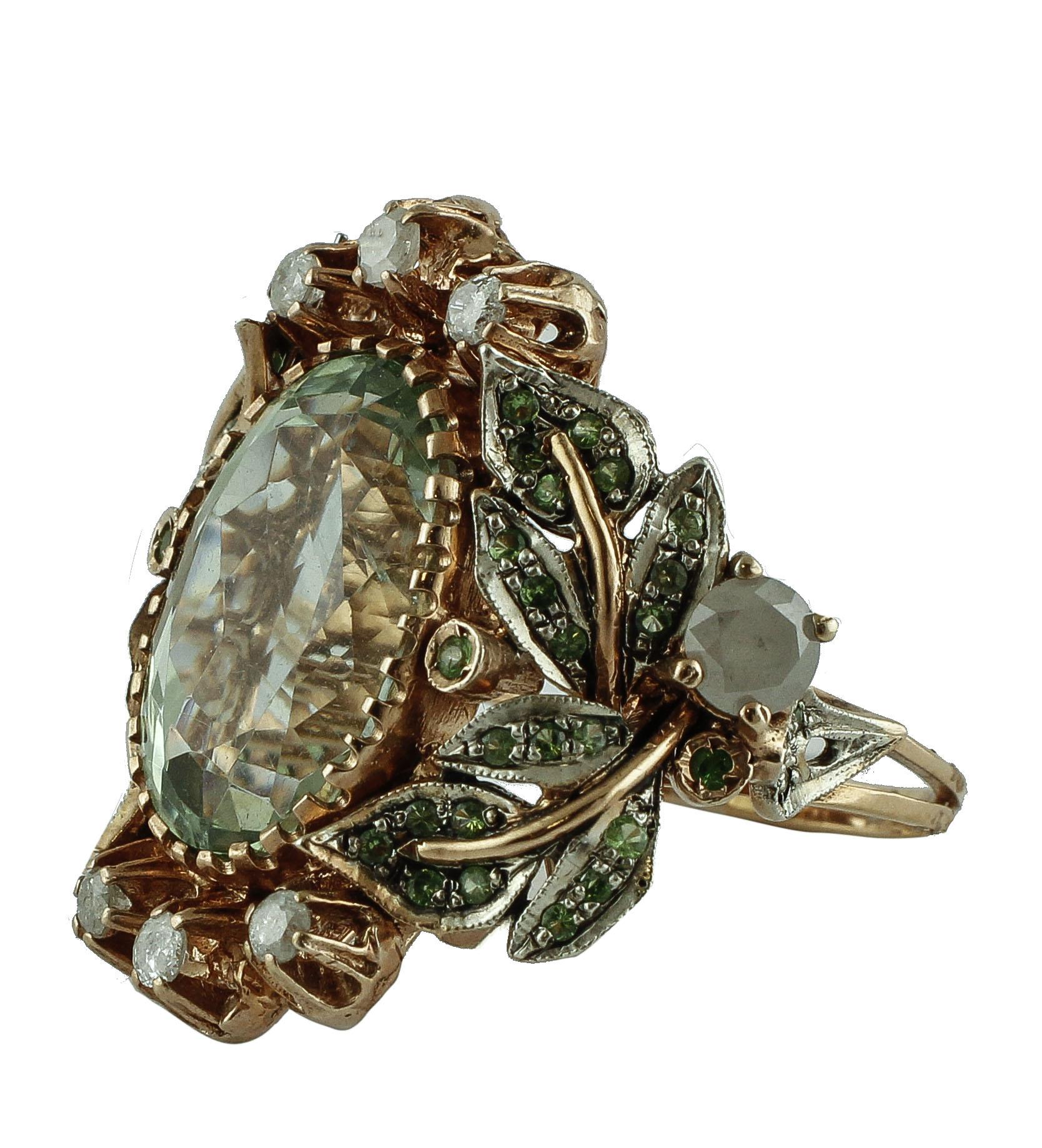Gorgeous cocktail ring in 9K rose gold and silver structure composed of 13.77 ct of deep color  big green amethyst with rose gold and silver detailes on the right and on the left studded by 0.69 ct little green tsavorite. Finally it is embellished