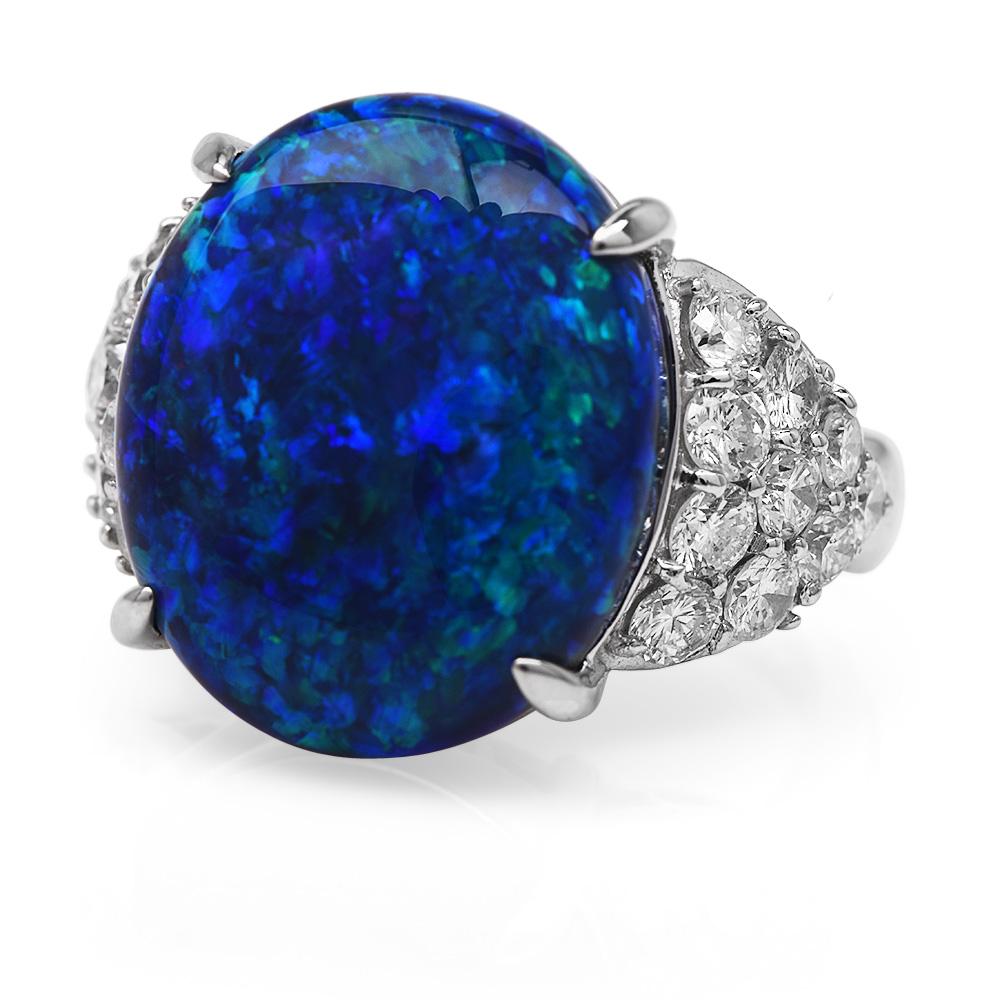This stunning Fine Black Opal diamond ring is crafted in solid platinum, weighing 14.1 grams and measureing18mm x 9mm high, GIA Certified.
Showcasing a prominent four-prong set cosmic genuine black opal weighing approximately