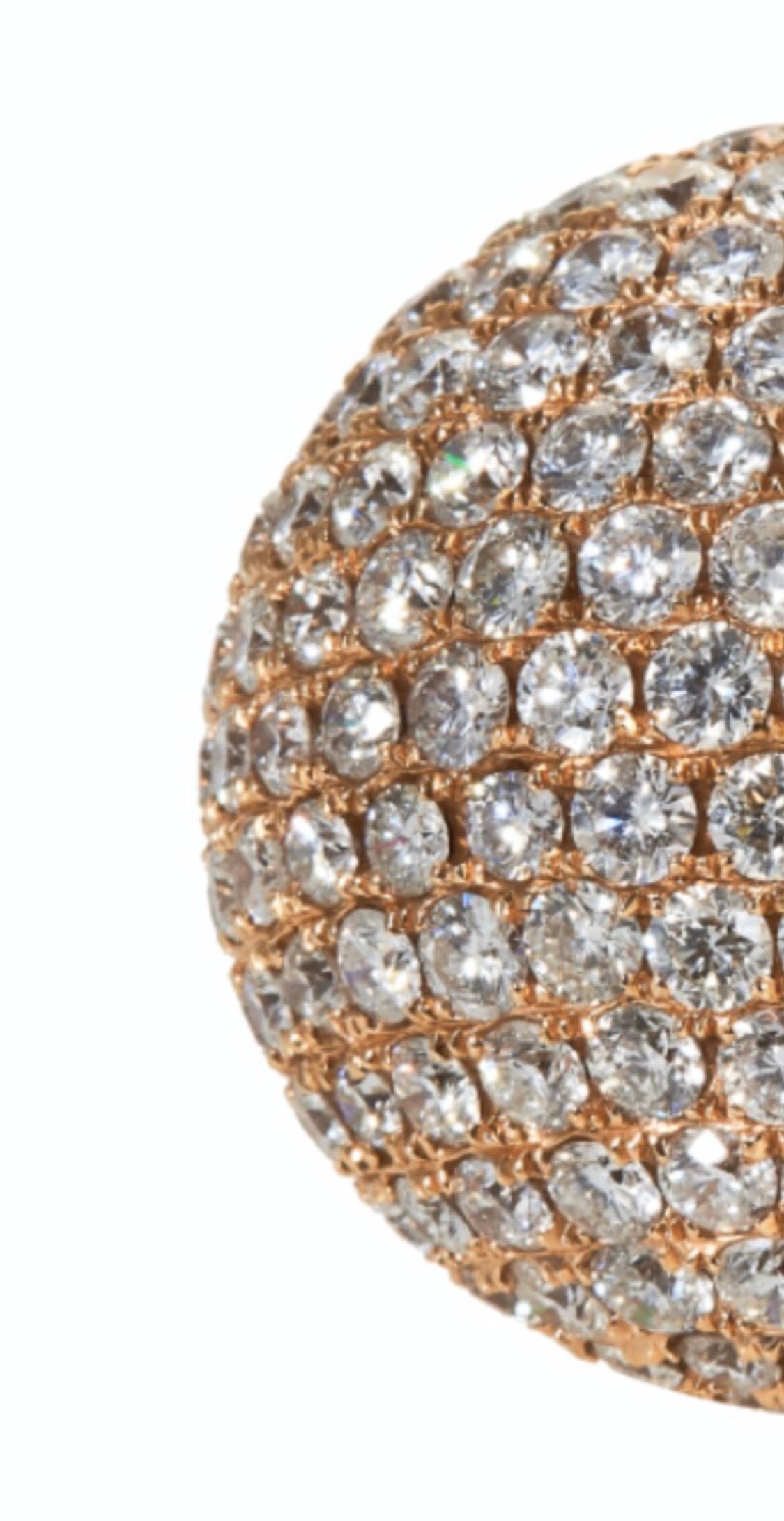 An Impressive 13.79 carat diamond bombe ring in 18 karart rose gold, the face jewelled with round cut diamonds totalling approximately 13.79 carats, this ring is stamped 18 Karat, size M / 6,  and weighing 27.56 grams.