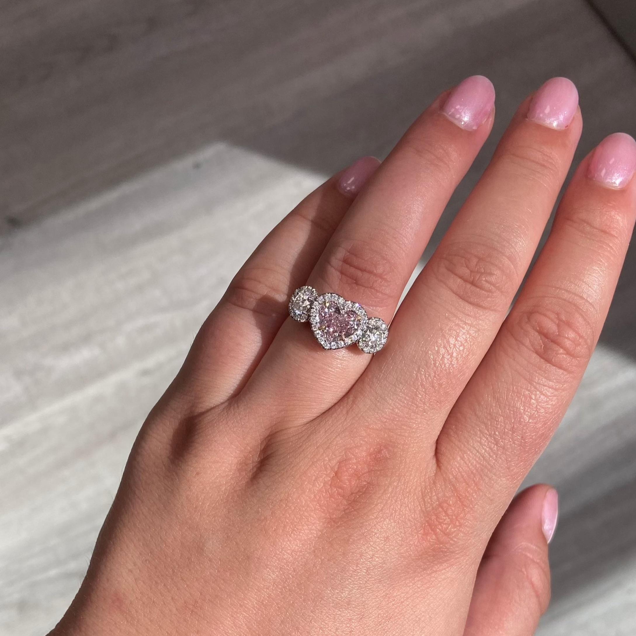 1.37 Carat Light Pink Heart Shape Diamond
SI1 Clarity 100% eye clean
No fluorescence
Platinum Ring set with 2 white diamond round side stones and soft white diamond halos
This piece can be viewed before purchase in our showroom in NYC or at one of