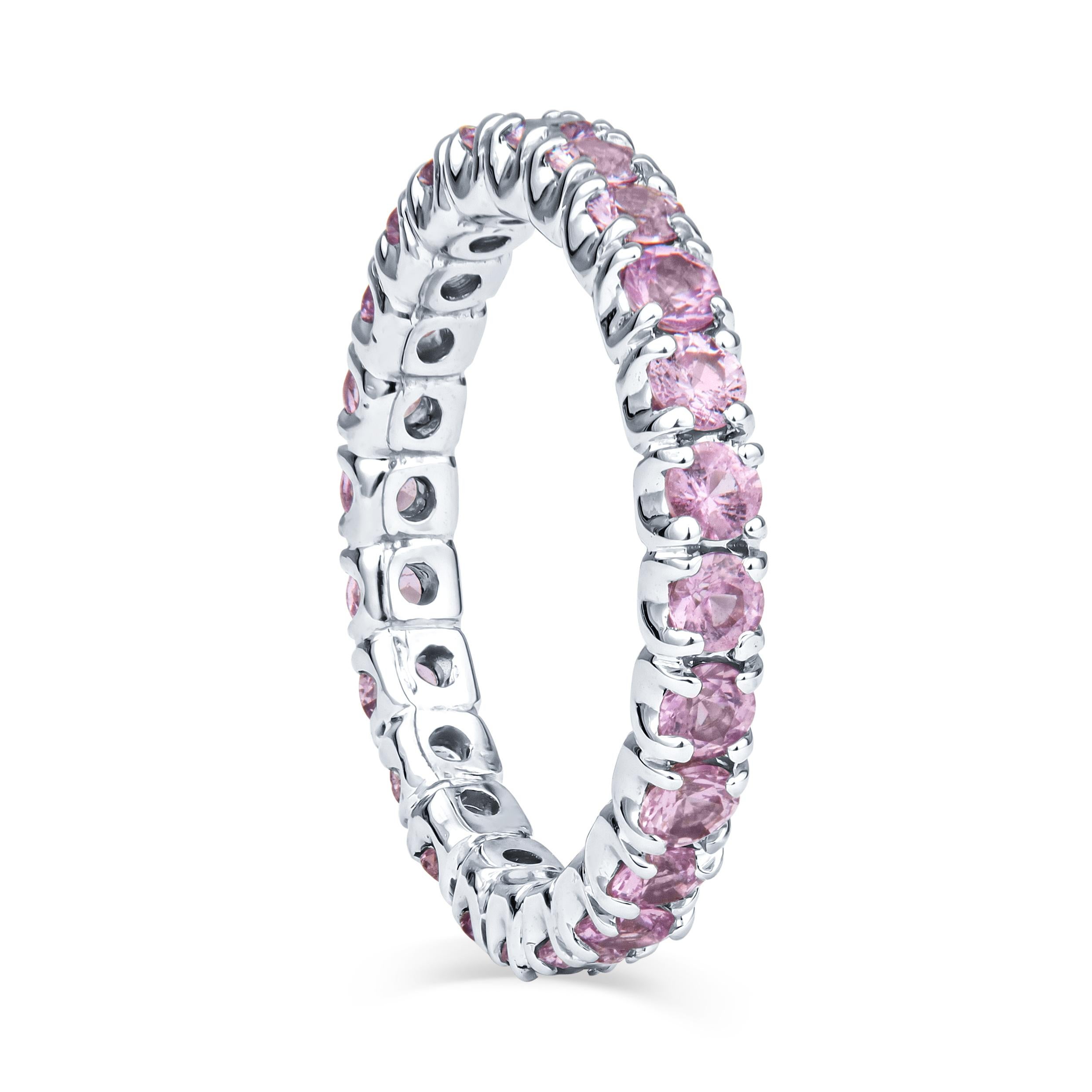 This precious stacking band is comprised of 1.37ct total weight in round, light pink sapphires, set in a 14kt white gold eternity band. It is currently a size 4; contact us for sizing options. This ring is a beautiful standalone piece, but it may