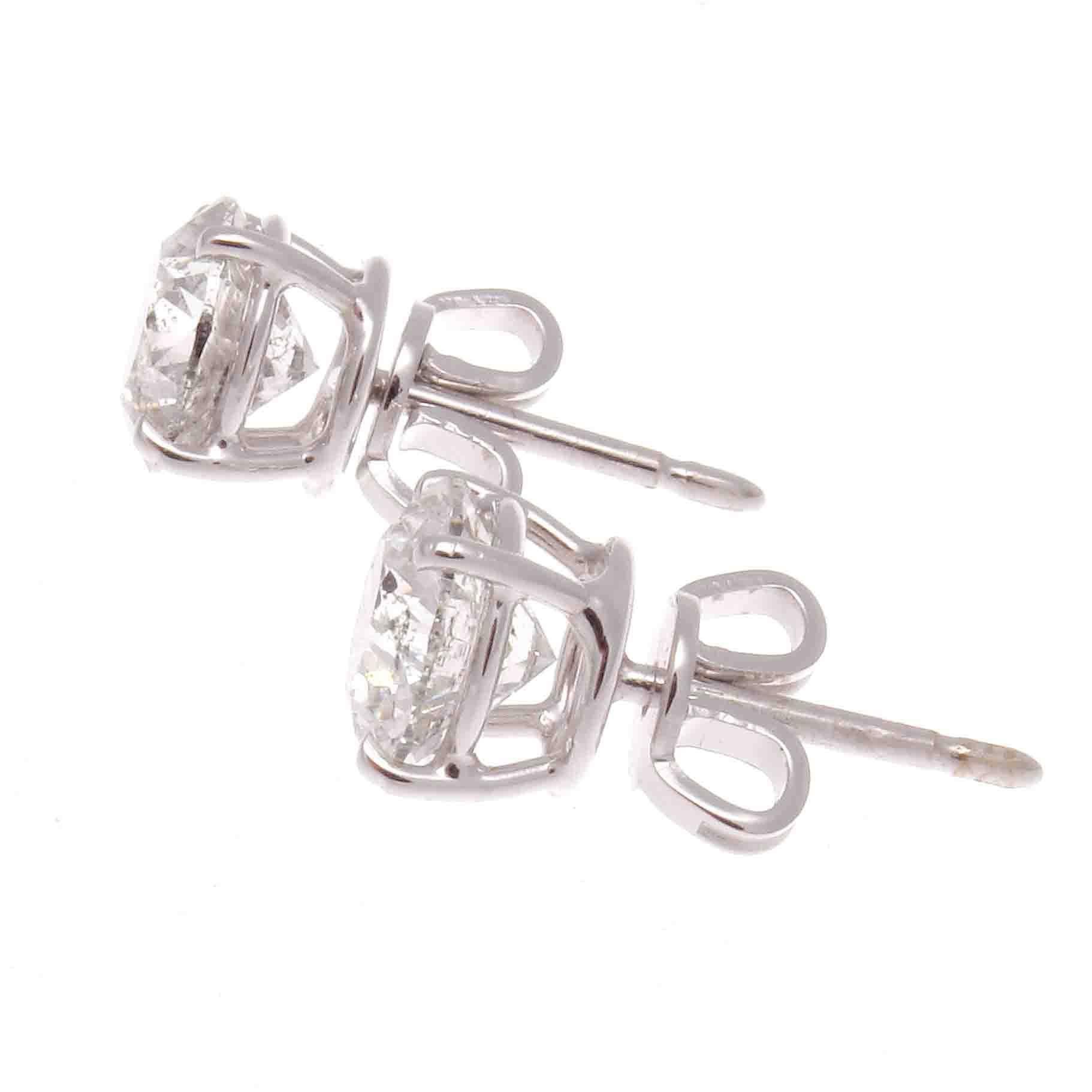 Elegance and sparkle radiates from the diamond stud earrings. Featuring a 1.34 carat and 1.38 carat round cut diamonds that are G-H color, I1 clarity. Crafted in platinum.