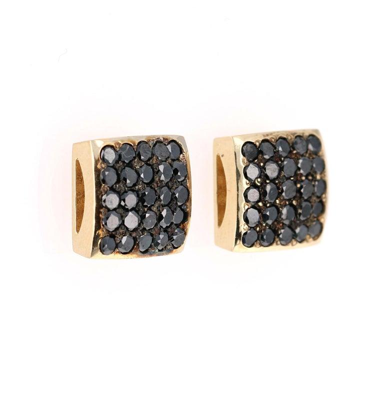 These earrings have 1.38 carats of Natural Round Cut Black Diamonds. 

They are curated in 14 Karat Yellow Gold and weigh approximately 5.6 grams

The width of the earrings are 10 mm. 