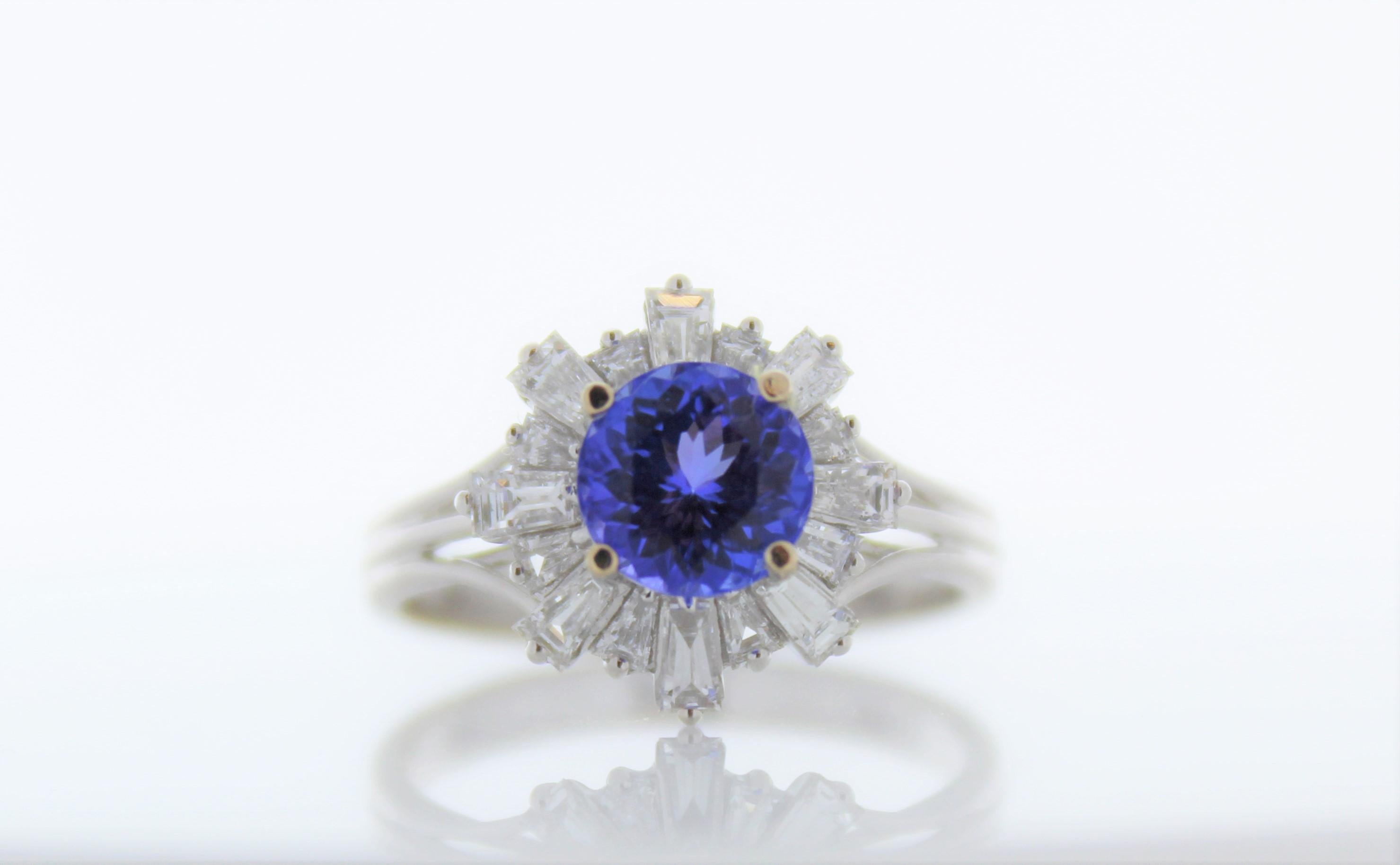 This is a cocktail ring that showcases a 1.38 carat cushion cut tanzanite. It has diamonds around the gemstone totaling .57 carats. Designed in brightly polished platinum, this gorgeous ring exudes sophistication and individual style.