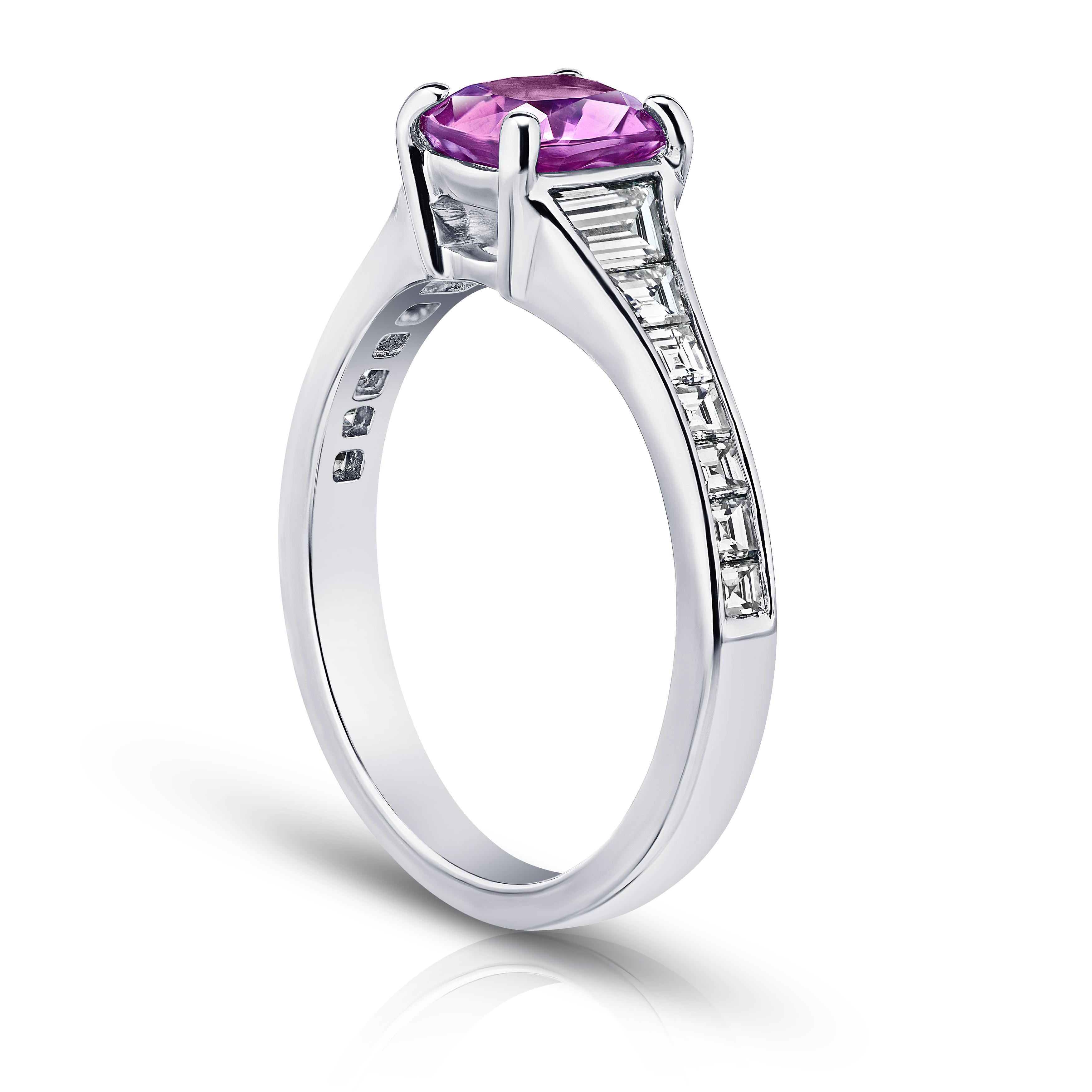 1.38 carat pink cushion sapphire with 14 trapezoid and carre diamonds .84 carats channel set in a platinum ring. 
This ring is currently a size 7.  We will resize to your finger size without charge.
