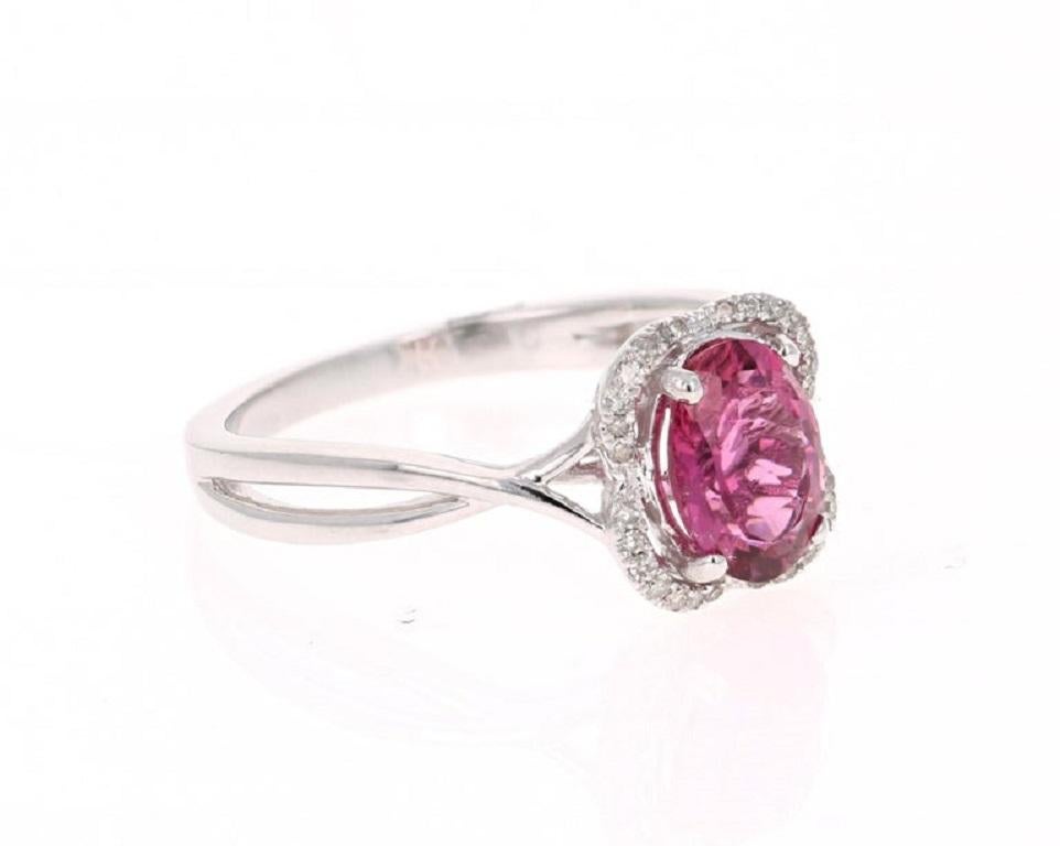 This ring has a gorgeous Oval Cut Pink Tourmaline that weighs 1.26 Carats. Floating around the tourmaline are 28 Round Cut Diamonds that weigh 0.12 Carats. The tourmaline measures at 8 mm x 6 mm. 

The total carat weight of the ring is 1.38 Carats.