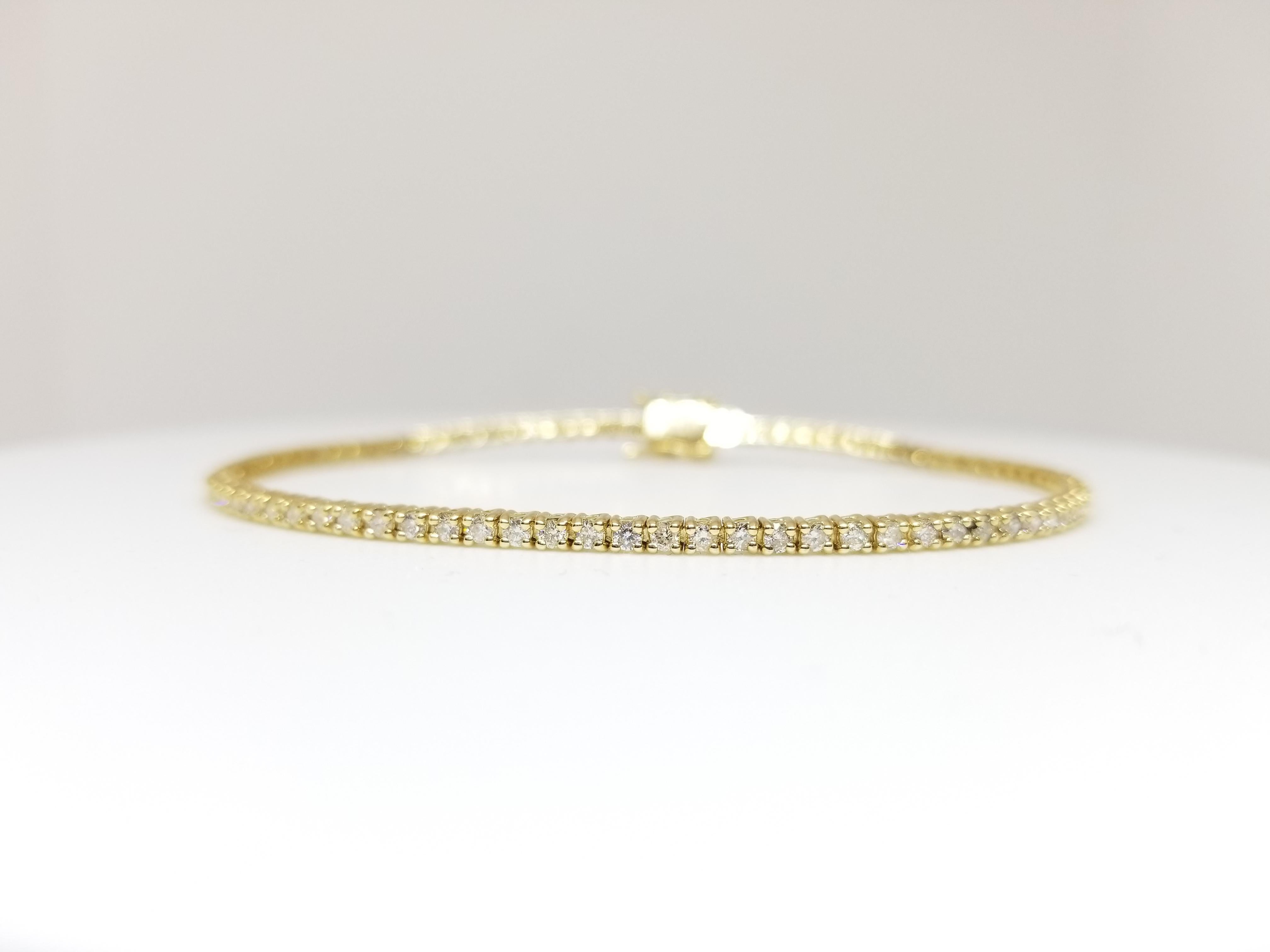 A quality tennis bracelet, round-brilliant cut diamonds. set on 14k yellow gold. each stone is set in a classic four-prong style for maximum light brilliance. 7 inch Length.
Average Color I, 
Average Clarity SI.
1.50 mm Width 