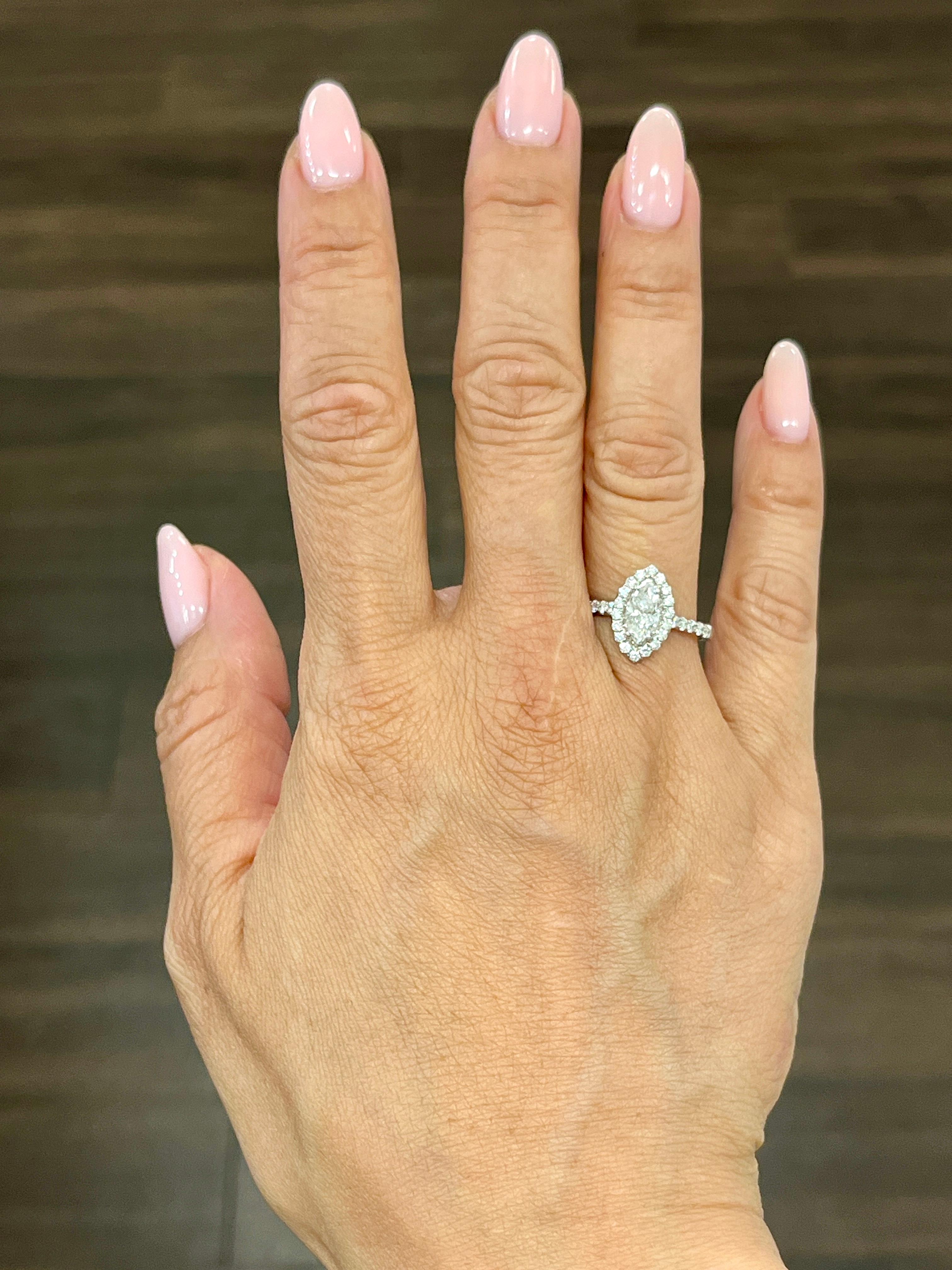 This stunning 1.38 carat diamond ring will make a beautiful addition to any jewelry collection. The sparkling marquise shaped diamond is set in 18k white gold, accented by 40 smaller diamonds. The ring is available in size 6.5 and is sizable.