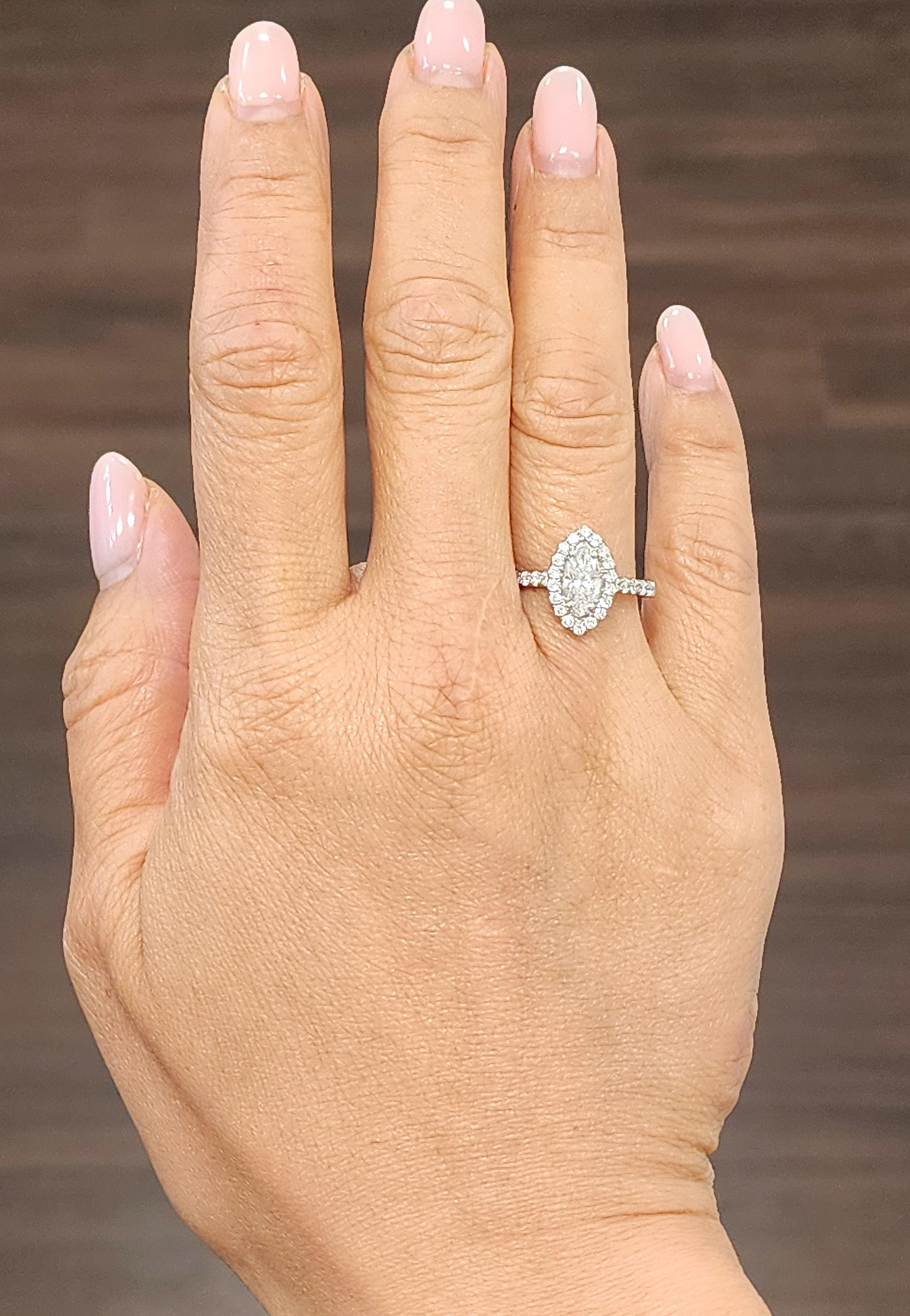 This stunning 1.38 carat diamond ring will make a beautiful addition to any jewelry collection. The sparkling marquise shaped diamond is set in 18k white gold, accented by 40 smaller diamonds. The ring is available in size 6.5 and is sizable.