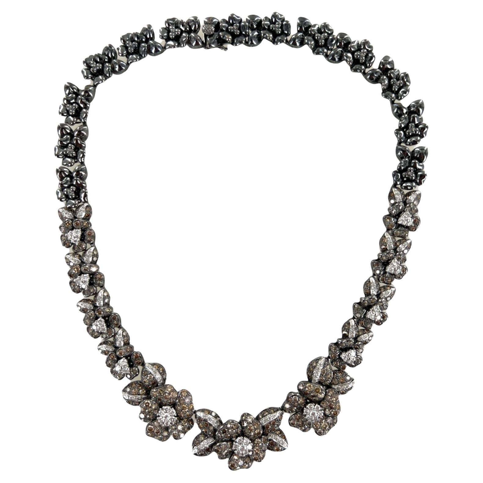 Beautifully crafted diamond floral necklace fashioned in 18 karat blackened gold. The necklace features 133 white round brilliant cut diamonds weighing approximately 4.00 carats and graded G-H color and VS2-SI1 clarity. The 328 champagne color