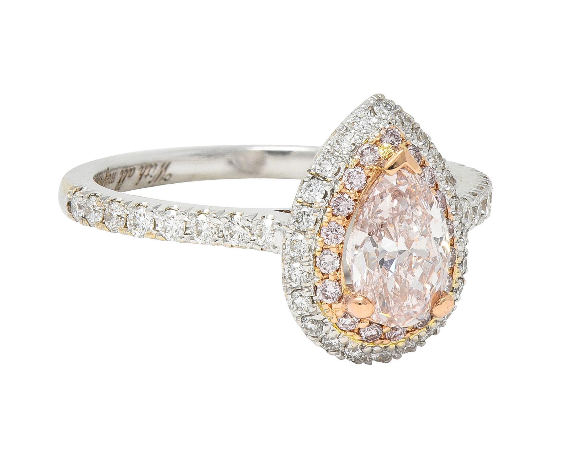 Centering a pear cut diamond weighing 0.81 carat prong set in yellow gold
Natural Fancy Light Brownish Pink in color with VS2 clarity
With a halo surround of round brilliant cut diamonds 
Fancy pink in color and well matched to center - bead set in