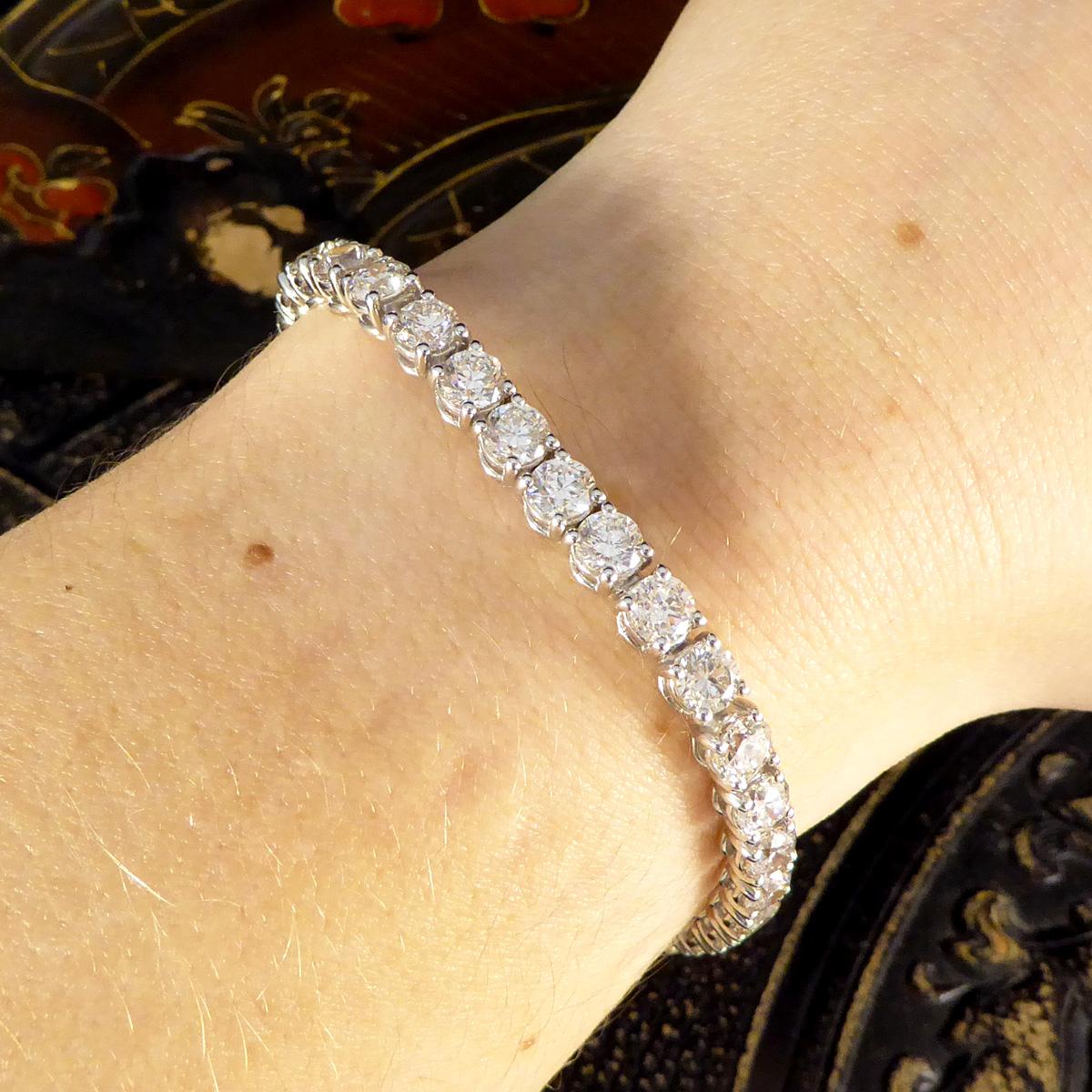 This gorgeous Tennis bracelet has been crafted in 18ct White Gold with a huge total of 13.80ct. Featuring a collection of 34 Modern Brilliant Cut Diamonds and a diamond set v snap box clasp and figure eight safety clasp for peace of mind. The