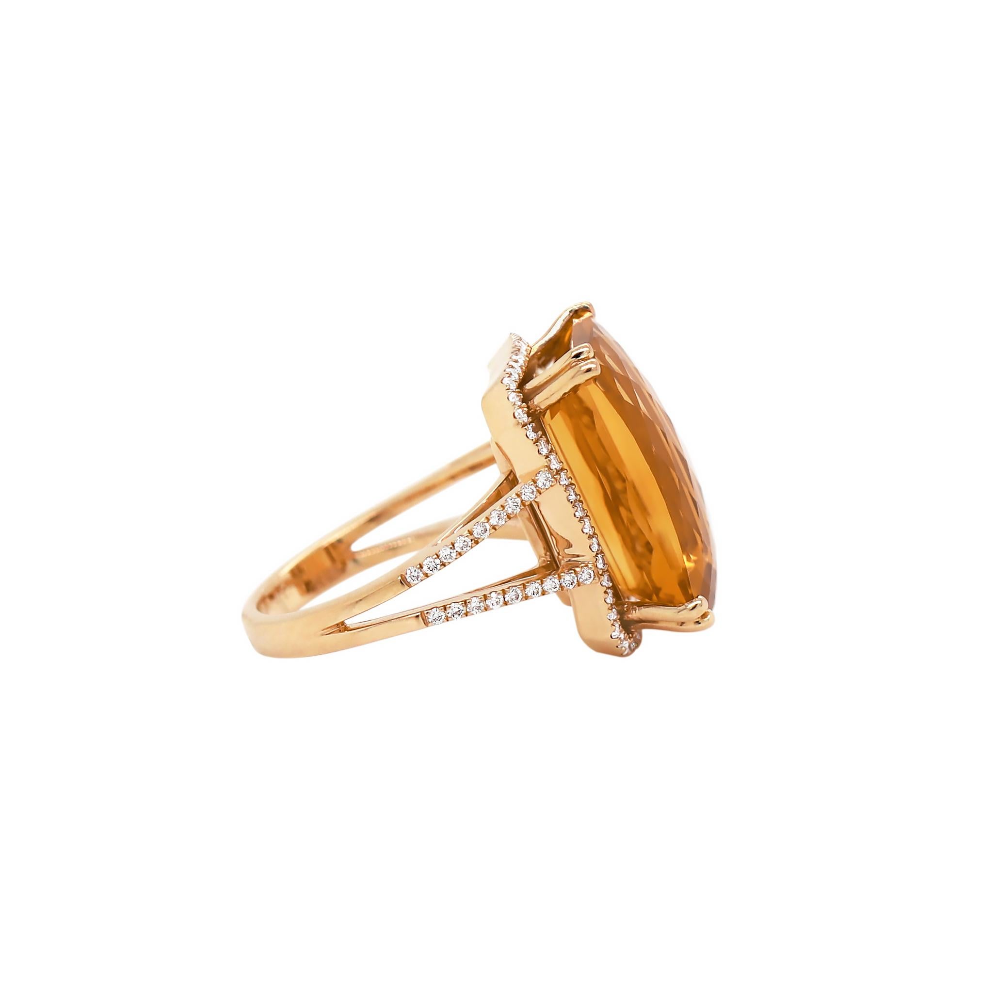 This beautiful cocktail ring features an intense and lively faceted rectangular citrine weighing 13.83ct in a four double claw setting. The stone is framed with a micro set halo of round brilliant cut diamonds and finally finished with diamond set