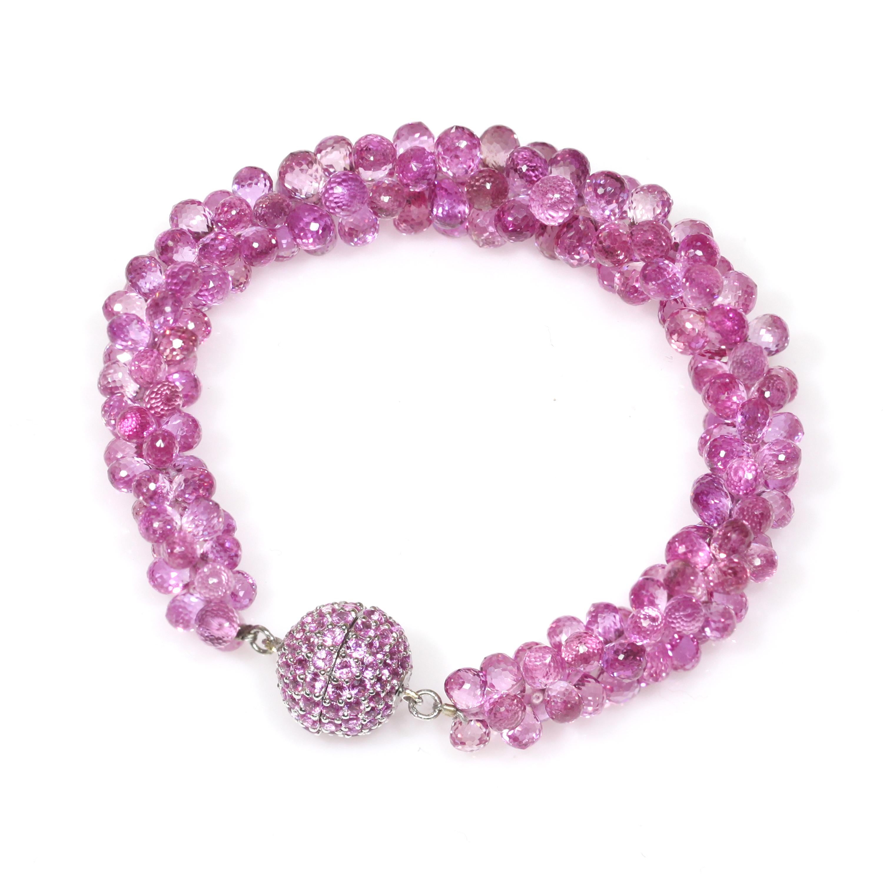 Crafted from 18k white gold, this beautiful bracelet features a long row of Pink Sapphire briolettes in proper unison, giving it the look of a vine, is secured with a bolo clasp and Pink Sapphire ball ends, and together forms a captivating jewelry