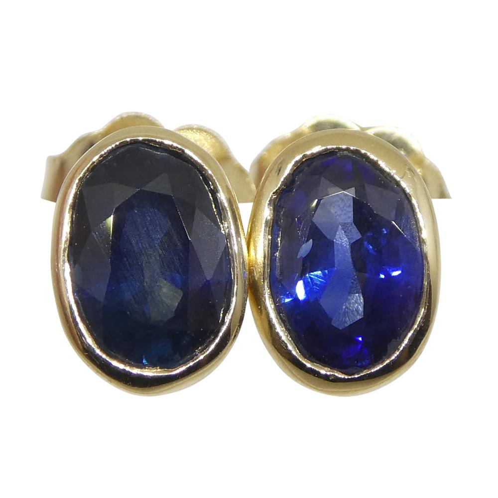 Contemporary 1.38ct Oval Blue Sapphire Stud Earrings set in 14k Yellow Gold For Sale