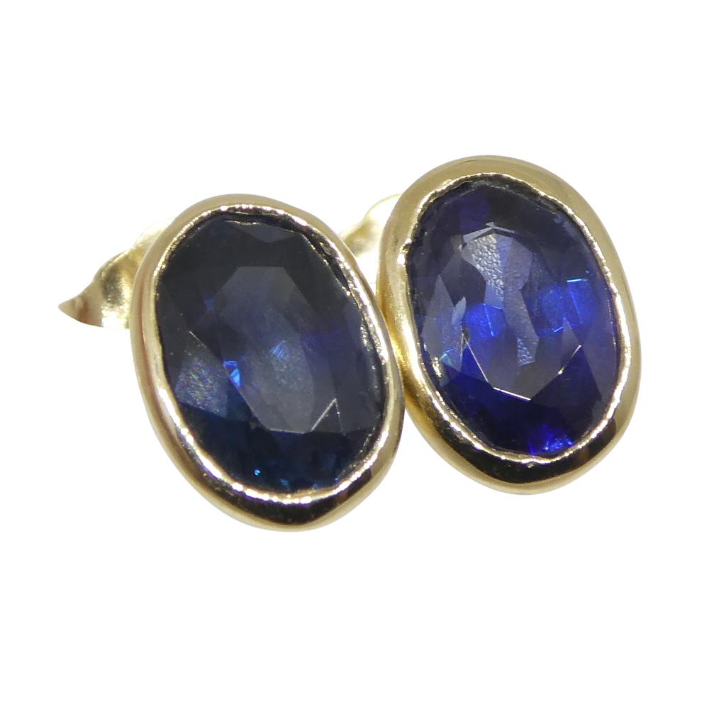 Brilliant Cut 1.38ct Oval Blue Sapphire Stud Earrings set in 14k Yellow Gold For Sale