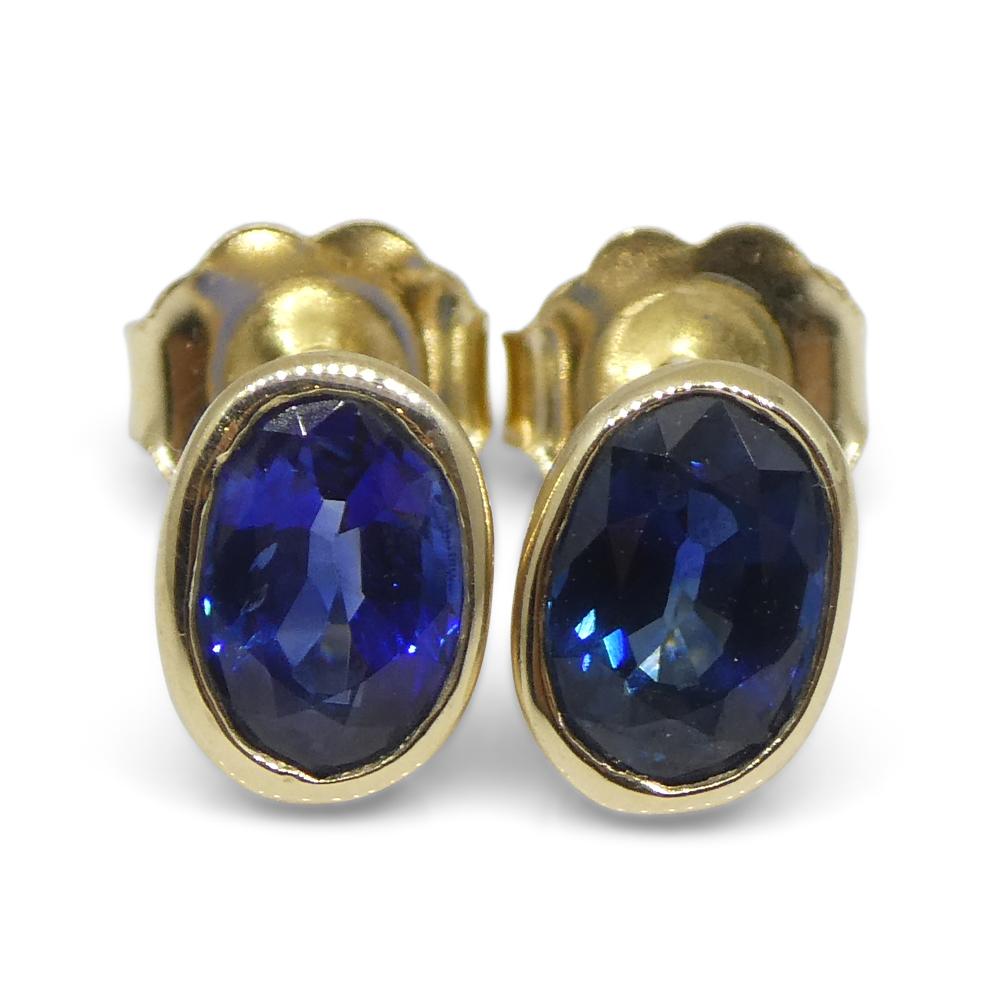Women's or Men's 1.38ct Oval Blue Sapphire Stud Earrings set in 14k Yellow Gold For Sale