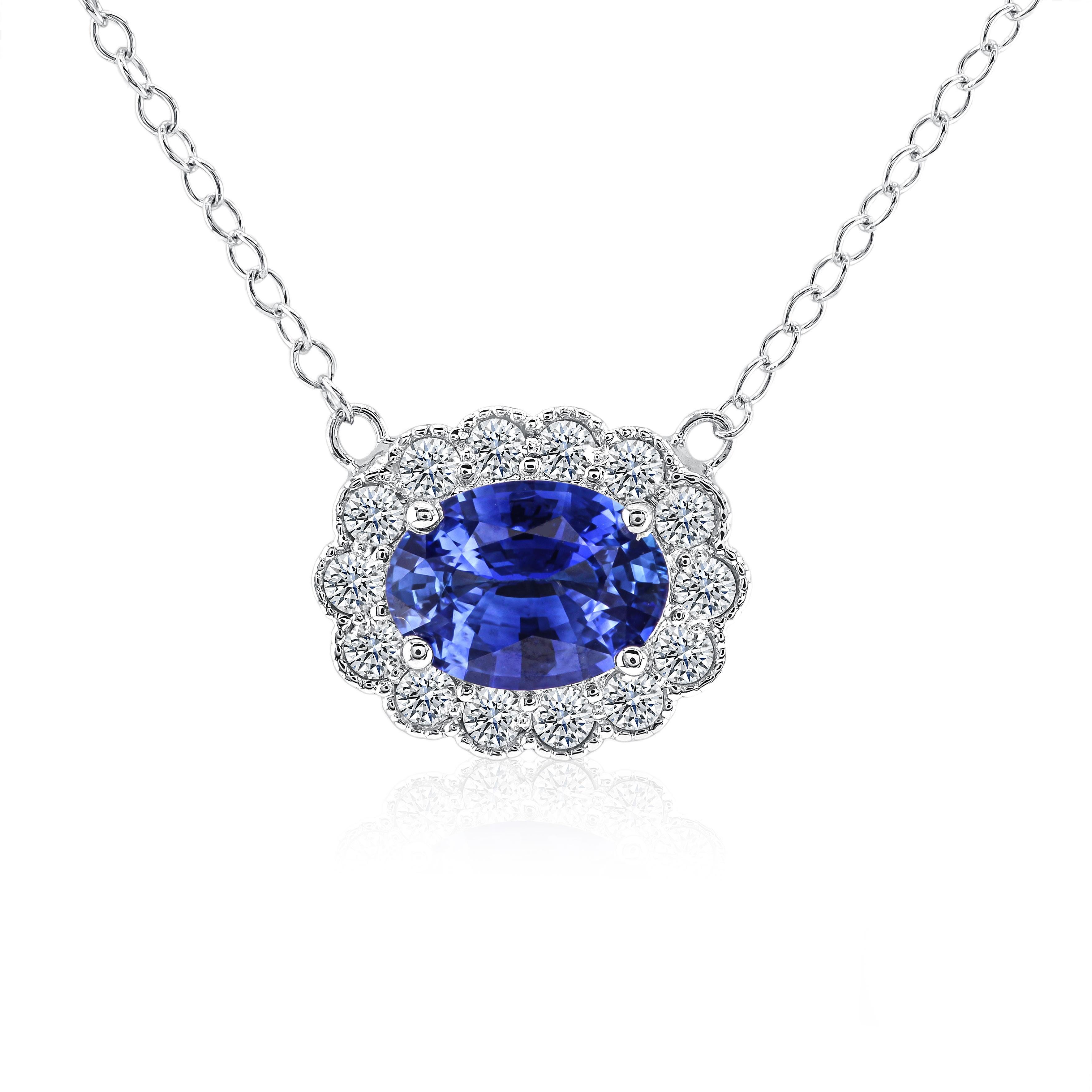 The epitome of opulence, this pendant features a 1.39 carat oval-cut sapphire, enveloped by a resplendent halo of 0.42 carats of round, natural white diamonds. The impeccable craftsmanship is evident in the intricate milgrain work meticulously