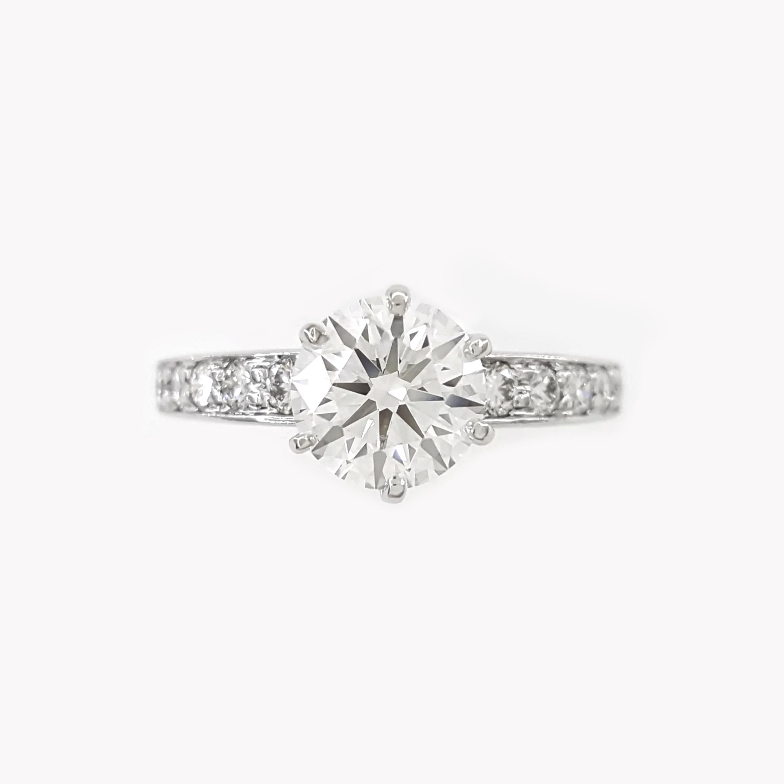 Tiffany & Co. Platinum Engagement Ring with 1.39 Carats of Round Brilliant Diamonds

This exquisite engagement ring by Tiffany & Co. is crafted in platinum and features a stunning bead-set design. The centerpiece is a 1.12-carat natural round