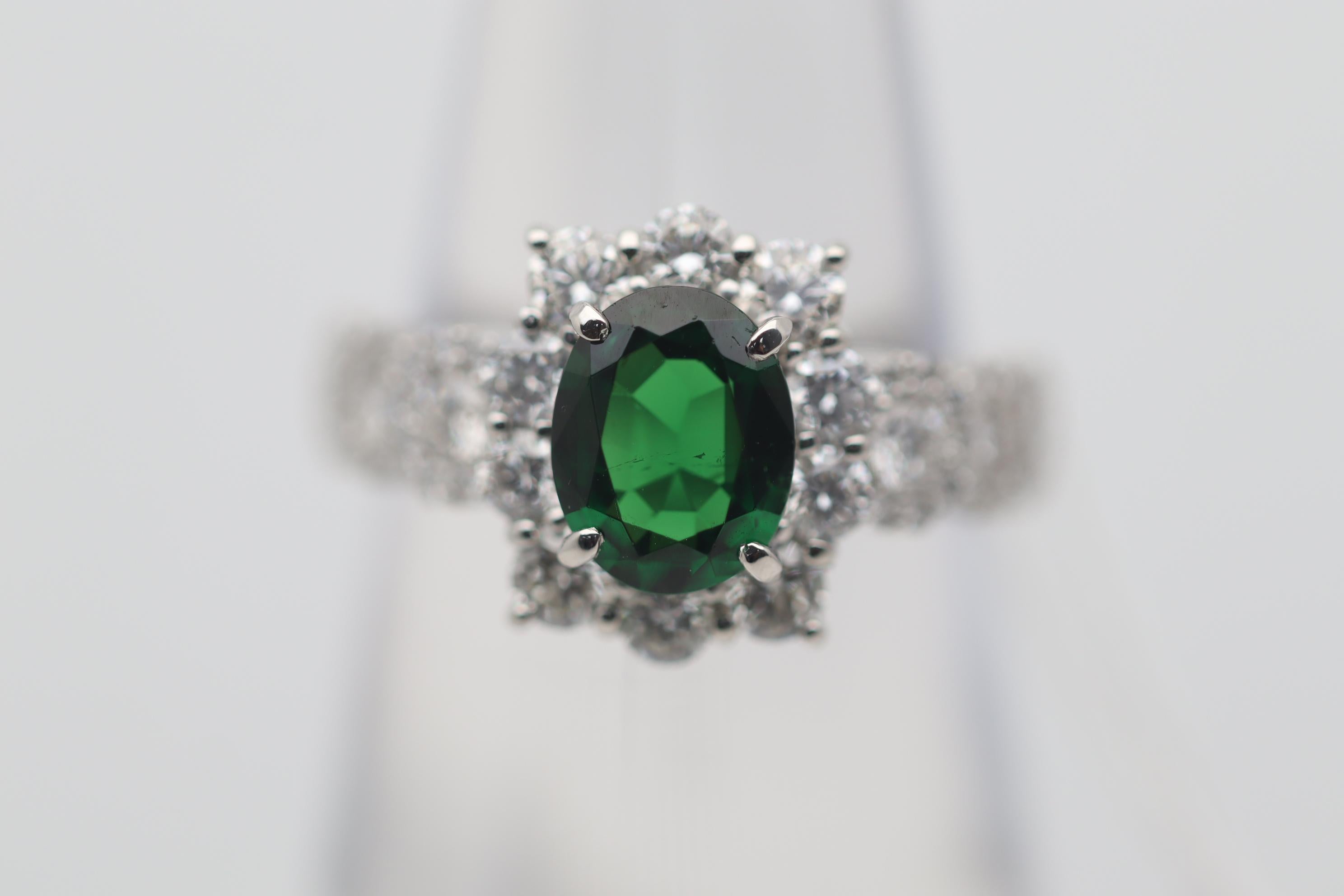 A fine platinum ring featuring a gem tsavorite weighing 1.39 carats. What makes this particular tsavorite special and gem quality is its rich intense green color that comes second to no other gemstone. It is complemented by 1.24 carats of round