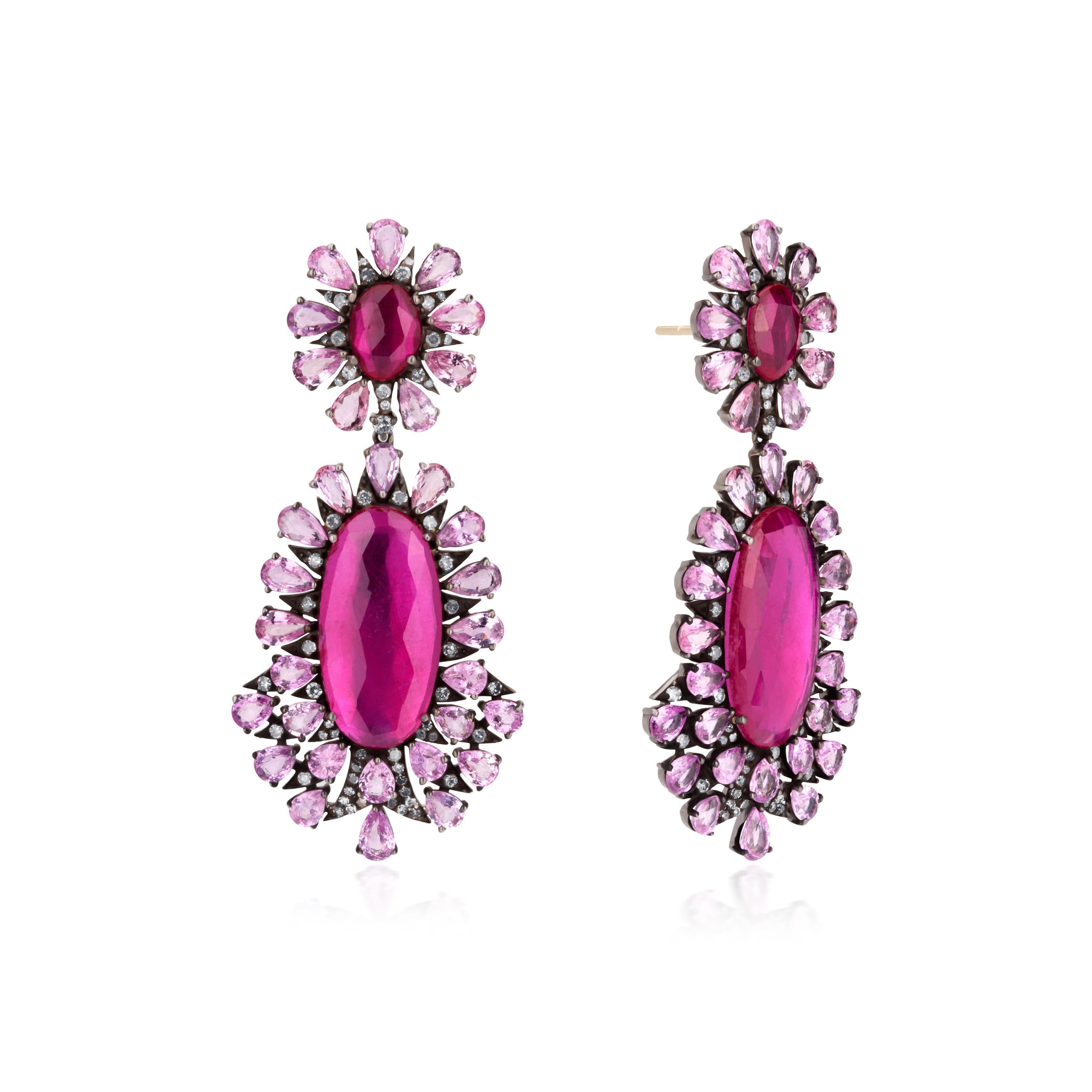 This beautifully matched pair of Victorian earrings showcase four raspberry red rubies together weighing 16.7Cts, glisten and glow within sparkling frames of faceted pink sapphires and diamonds at the top and the drop, all classically presented in