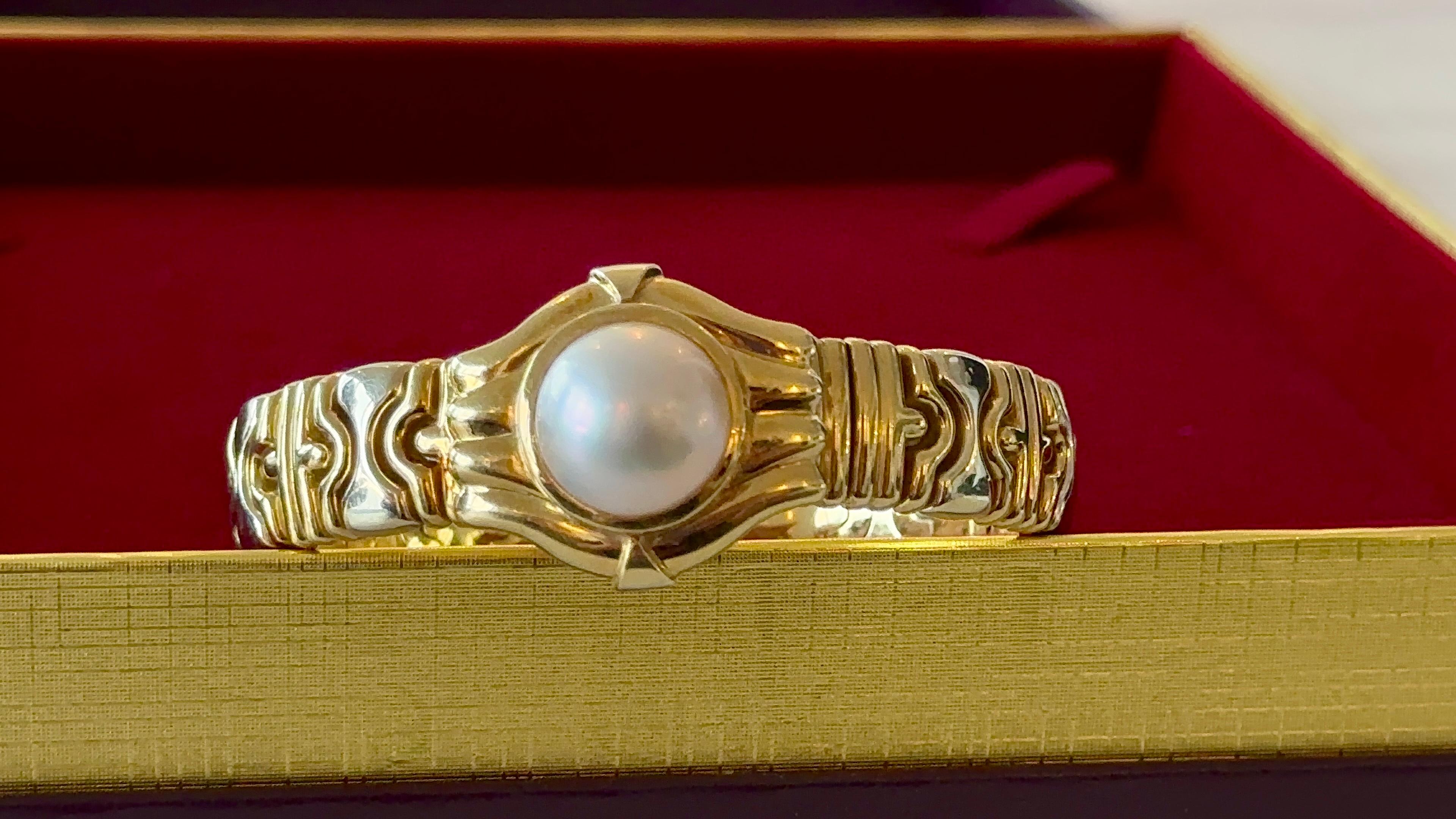 Italian vintage solid gold bracelet with 13.9mm natural pearl set in center. 
Bracelet size: adjustable, open bangle.
Natural pearl size: 13.9 mm.
Metal: 18K solid gold.
Gold weight: 46.6 grams.