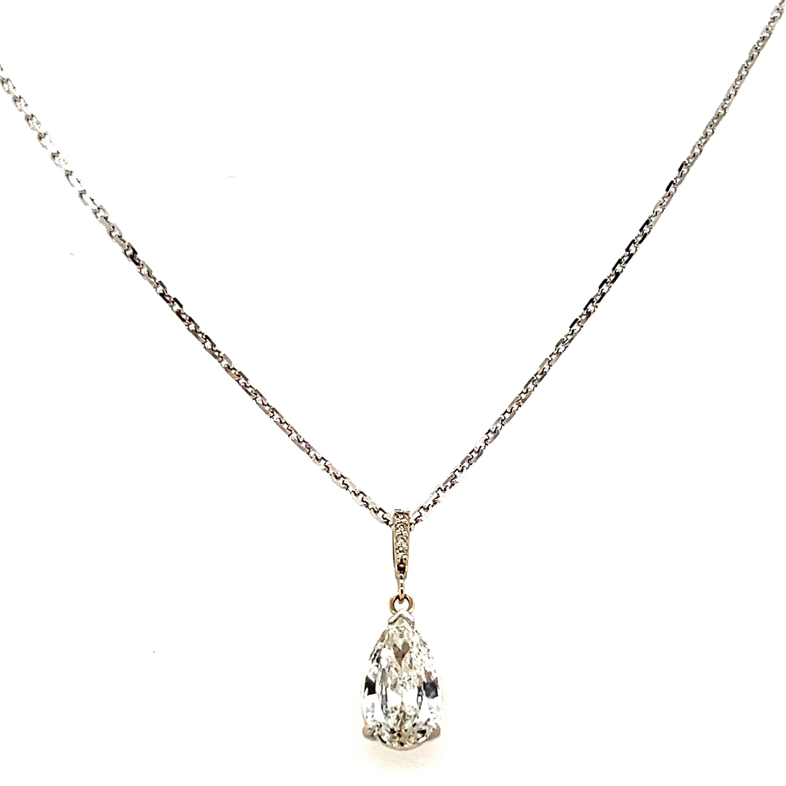 This elegant 14 karat white gold pendant features a stunning pear-shaped diamond, approximately 1.39 carats, with H color and SI1 clarity. Accentuating the centerpiece are four round brilliant diamonds with a total carat weight of 0.03, offering