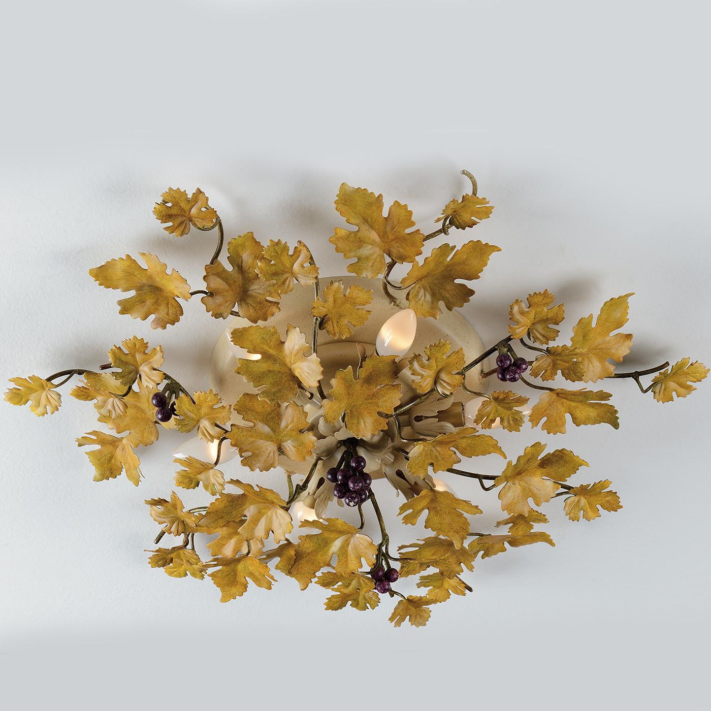 This charming metal ceiling lamp almost seems to be more of a decorative piece than a light fixture, as it has been hand-decorated with golden grape leaves and small bunches of grapes. Six small bulbs give off light nestled among the leaves. \nLight